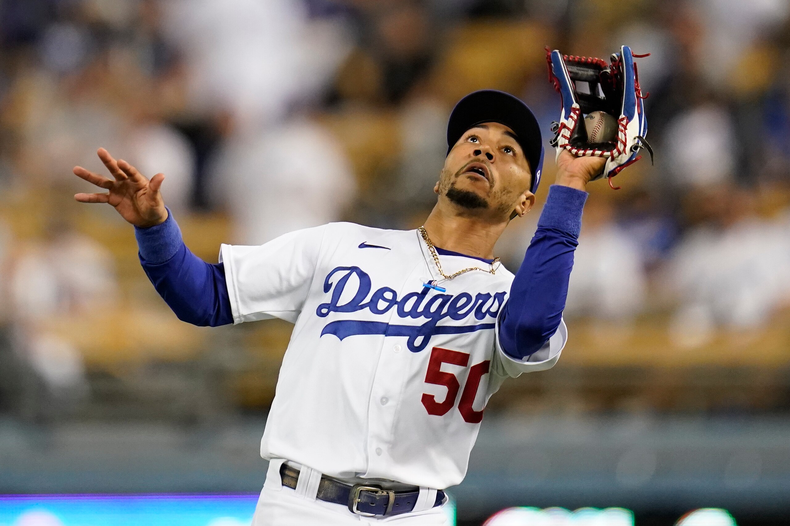 Los Angeles Dodgers right fielder Mookie Betts (50) catches a fly ball hit by San Diego Padres' Tommy Pham during the ninth inning of a baseball game Thursday, Sept. 30, 2021, in Los Angeles. (AP Photo/Ashley Landis) Los Angeles Dodgers right fielder Mookie Betts (50) catches a fly ball hit by San Diego Padres' Tommy Pham during the ninth inning of a baseball game Thursday, Sept. 30, 2021, in Los Angeles. (AP Photo/Ashley Landis)