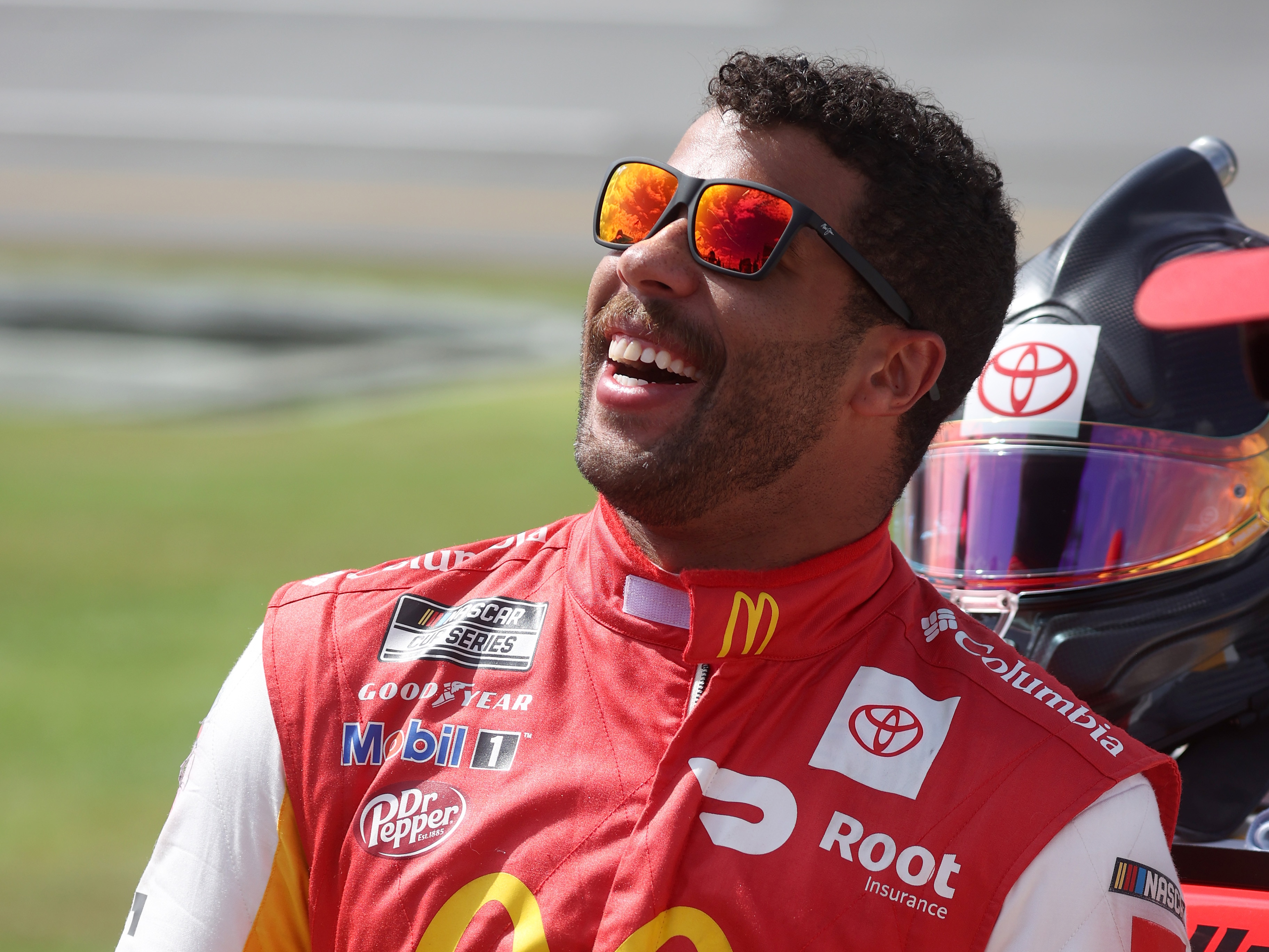 TALLADEGA, ALABAMA - OCTOBER 04: Bubba Wallace, driver of the #23 McDonald's Toyota, stands on the grid prior to the NASCAR Cup Series YellaWood 500 at Talladega Superspeedway on October 04, 2021 in Talladega, Alabama. (Photo by Chris Graythen/Getty Images)