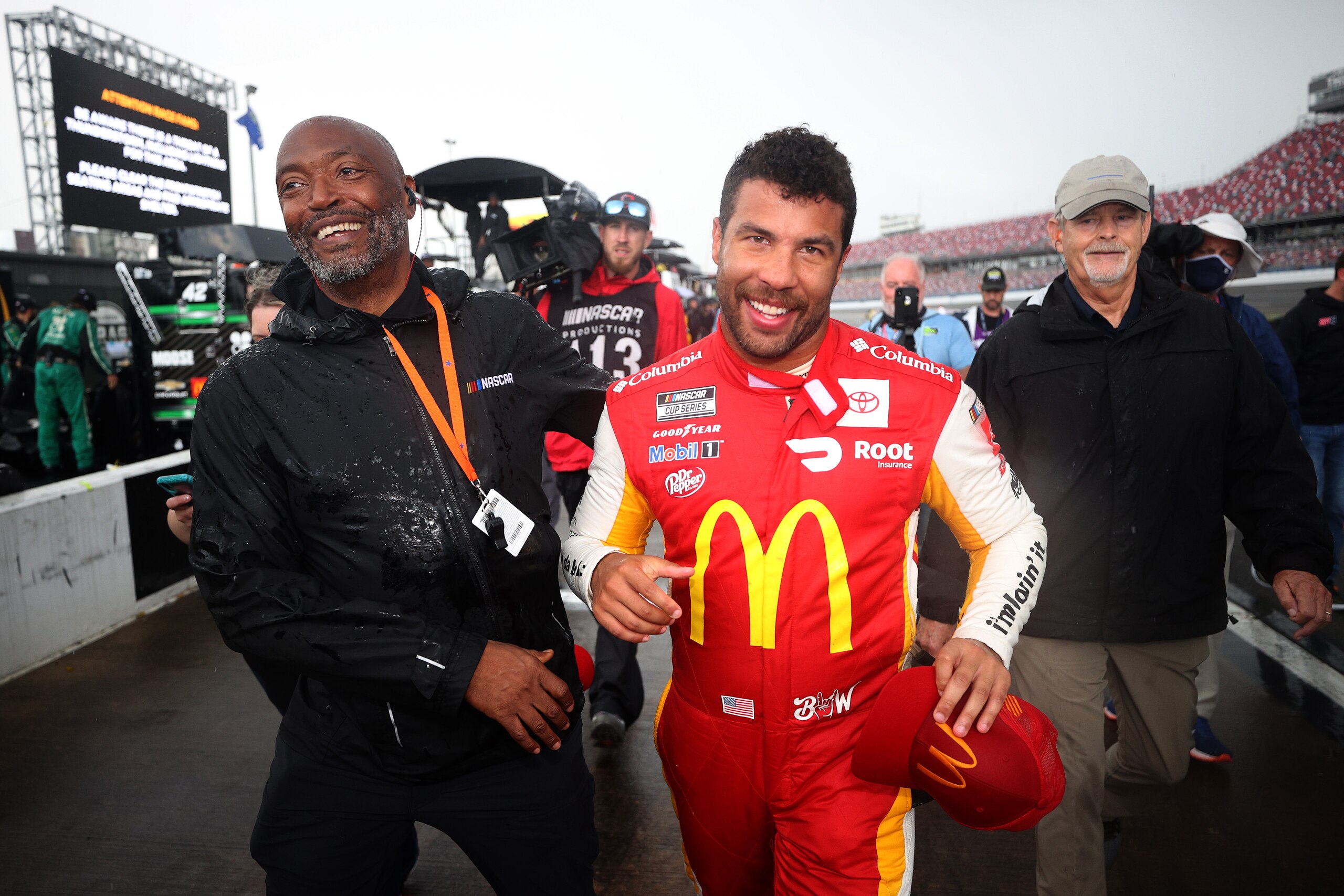 TALLADEGA, ALABAMA - OCTOBER 04: Bubba Wallace, driver of the #23 McDonald's Toyota, walks the grid after winning the rain-shortened NASCAR Cup Series YellaWood 500 at Talladega Superspeedway on October 04, 2021 in Talladega, Alabama. (Photo by Chris Graythen/Getty Images)