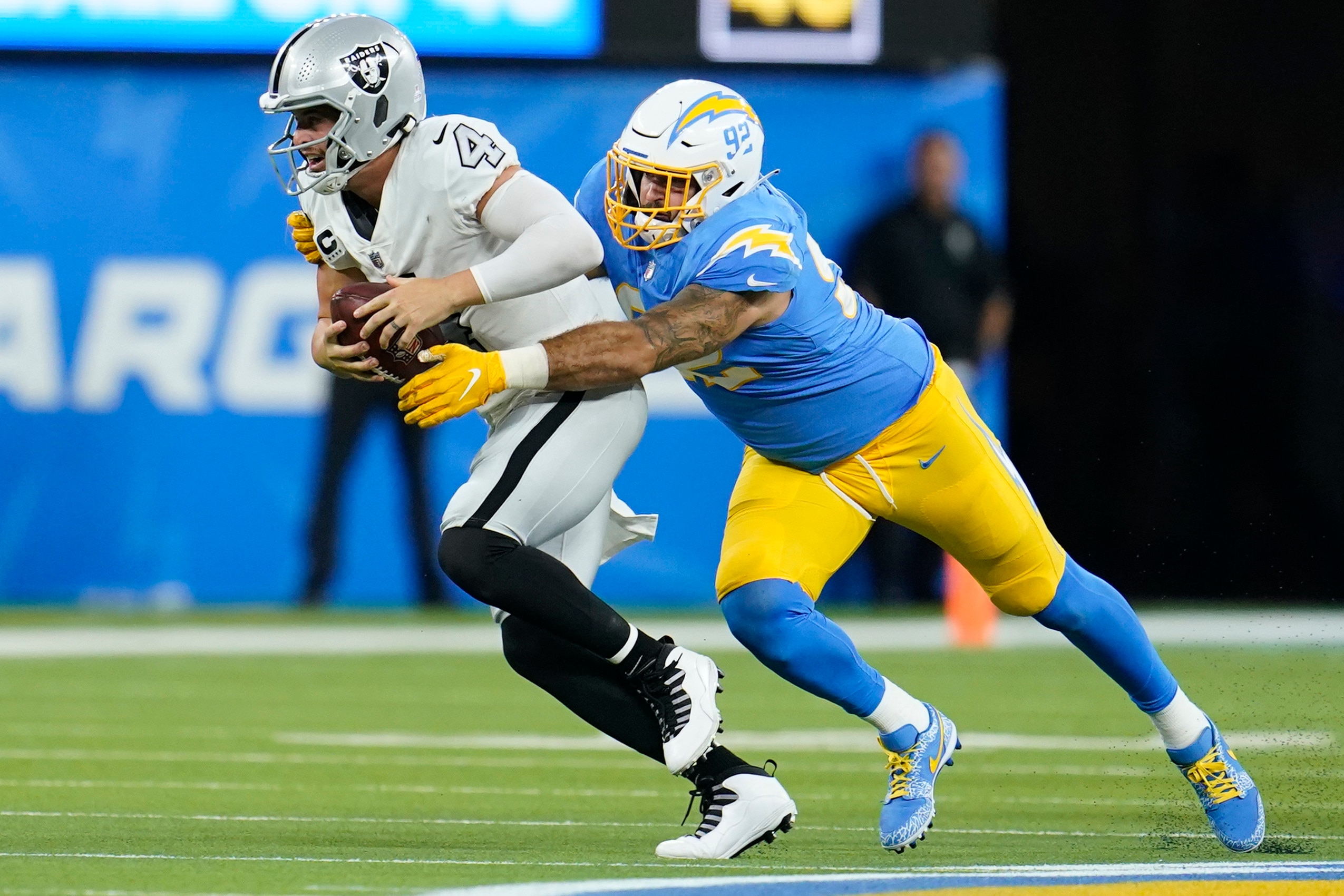 Los Angeles Chargers defensive end Joe Gaziano hauls down Las Vegas Raiders quarterback Derek Carr for a sack during the second half of an NFL football game Monday, Oct. 4, 2021, in Inglewood, Calif. (AP Photo/Marcio Jose Sanchez)