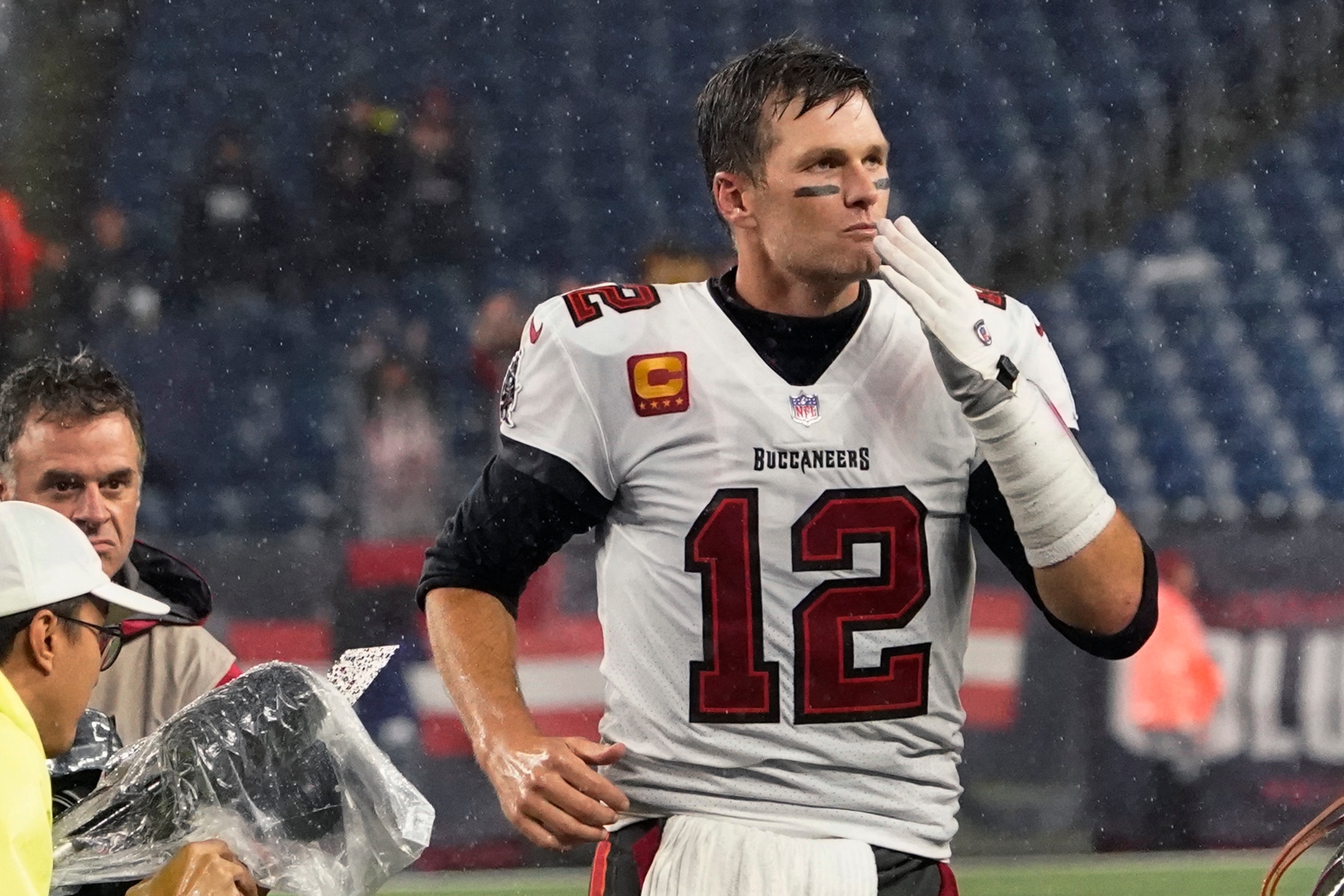 Tampa Bay Buccaneers quarterback Tom Brady (12) blows a kiss to fans as he leaves the field at Gillette Stadium after defeating the New England Patriots 19-17 in an NFL football game, Sunday, Oct. 3, 2021, in Foxborough, Mass. (AP Photo/Elise Amendola)
