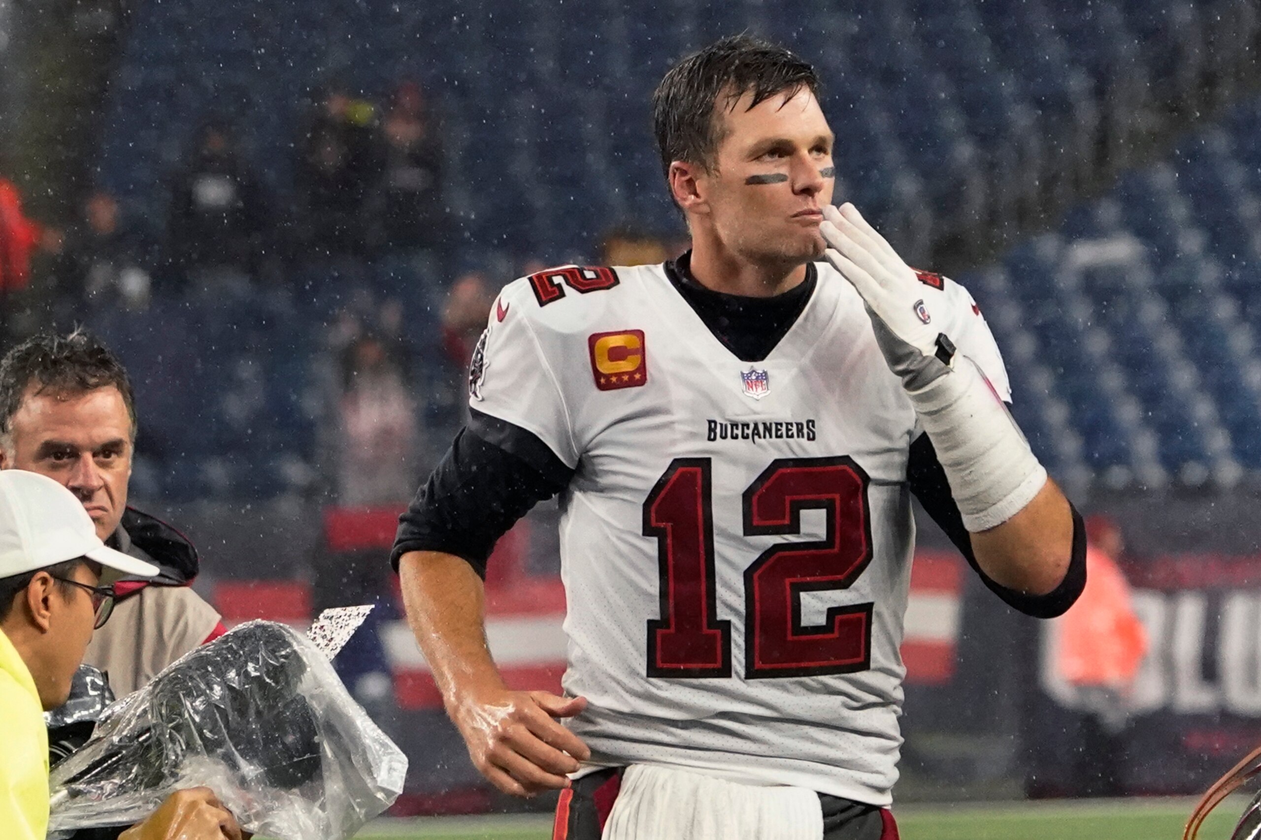 Tampa Bay Buccaneers quarterback Tom Brady (12) blows a kiss to fans as he leaves the field at Gillette Stadium after defeating the New England Patriots 19-17 in an NFL football game, Sunday, Oct. 3, 2021, in Foxborough, Mass. (AP Photo/Elise Amendola)