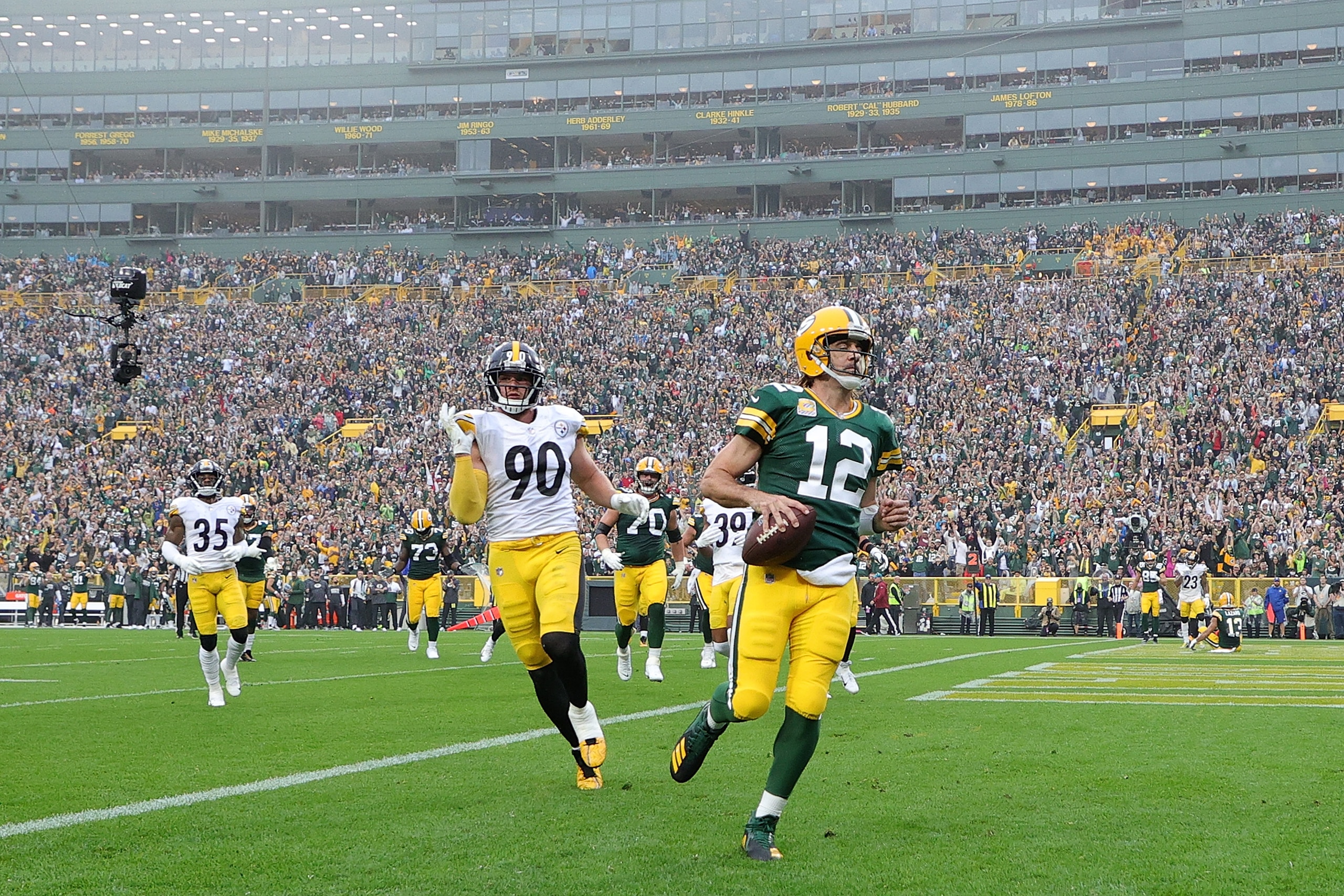 GREEN BAY, WISCONSIN - OCTOBER 03: Aaron Rodgers #12 of the Green Bay Packers rushes for a touchdown during a game against the Pittsburgh Steelers at Lambeau Field on October 03, 2021 in Green Bay, Wisconsin. (Photo by Stacy Revere/Getty Images)