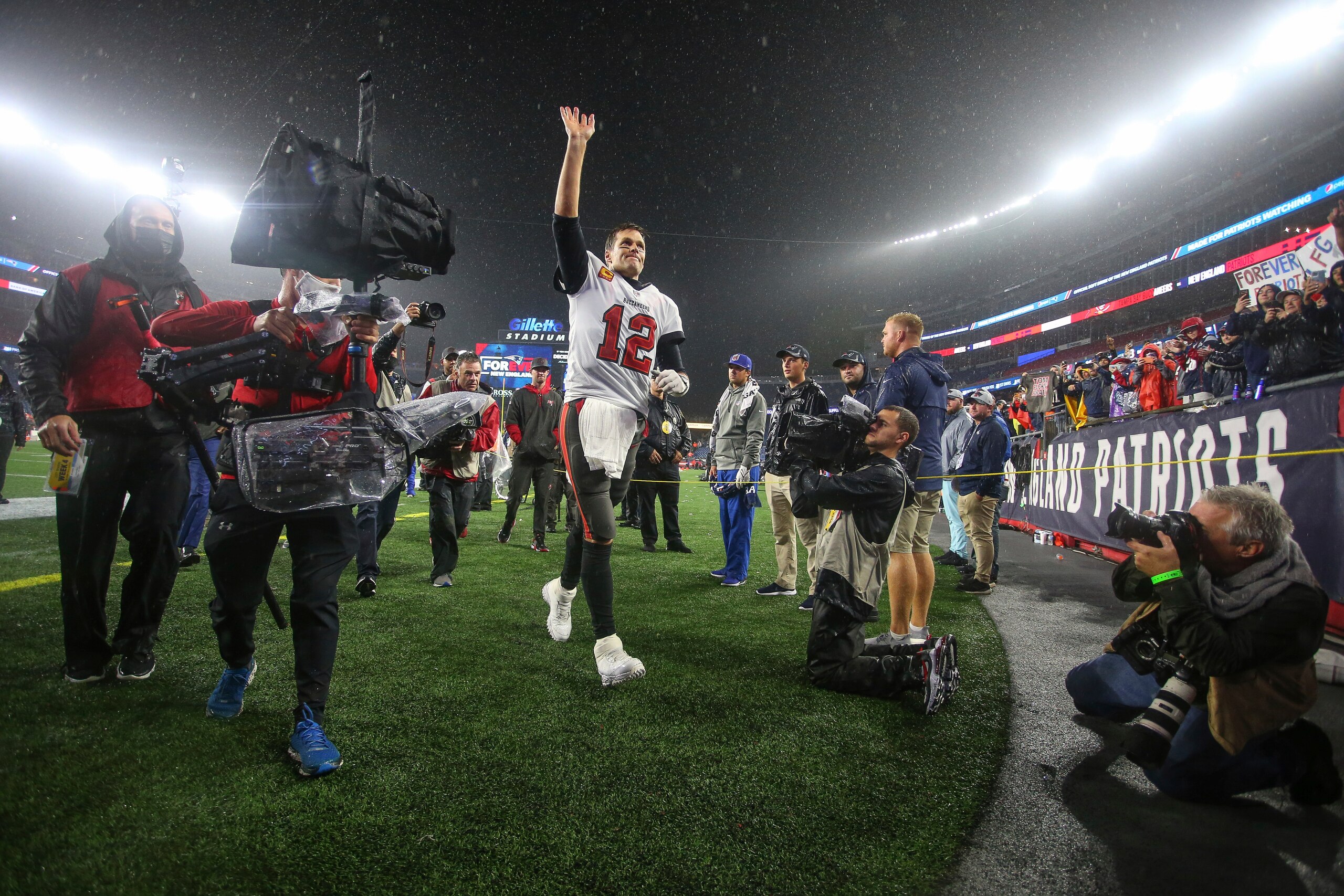 Tampa Bay Buccaneers quarterback Tom Brady (12) waves to the crowd as he runs off the field following an NFL football game against the New England Patriots, Sunday, Oct. 3, 2021, in Foxborough, Mass. (AP Photo/Stew Milne)
