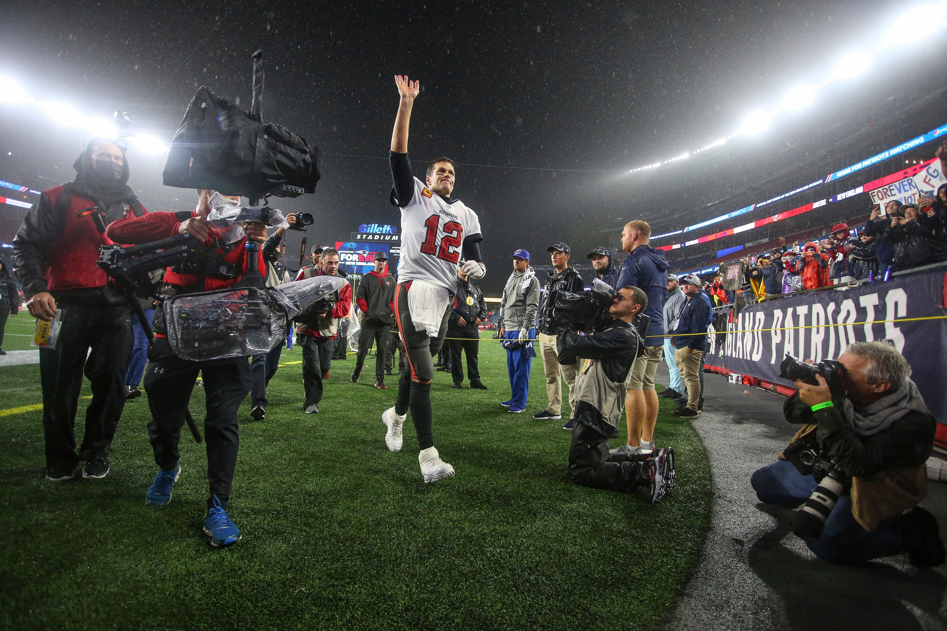 Tampa Bay Buccaneers quarterback Tom Brady (12) waves to the crowd as he runs off the field following an NFL football game against the New England Patriots, Sunday, Oct. 3, 2021, in Foxborough, Mass. (AP Photo/Stew Milne)