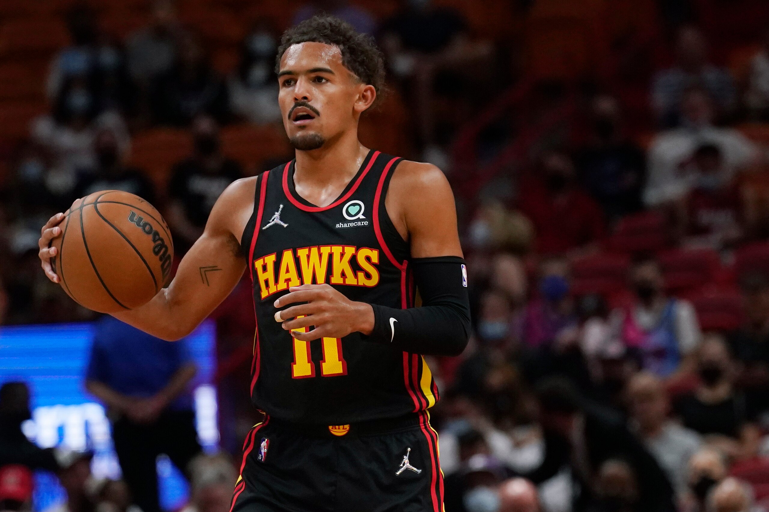 Atlanta Hawks guard Trae Young (11) dribbles the ball during the first half of a preseason NBA basketball game against the Miami Heat, Monday, Oct. 4, 2021, in Miami. (AP Photo/Marta Lavandier)