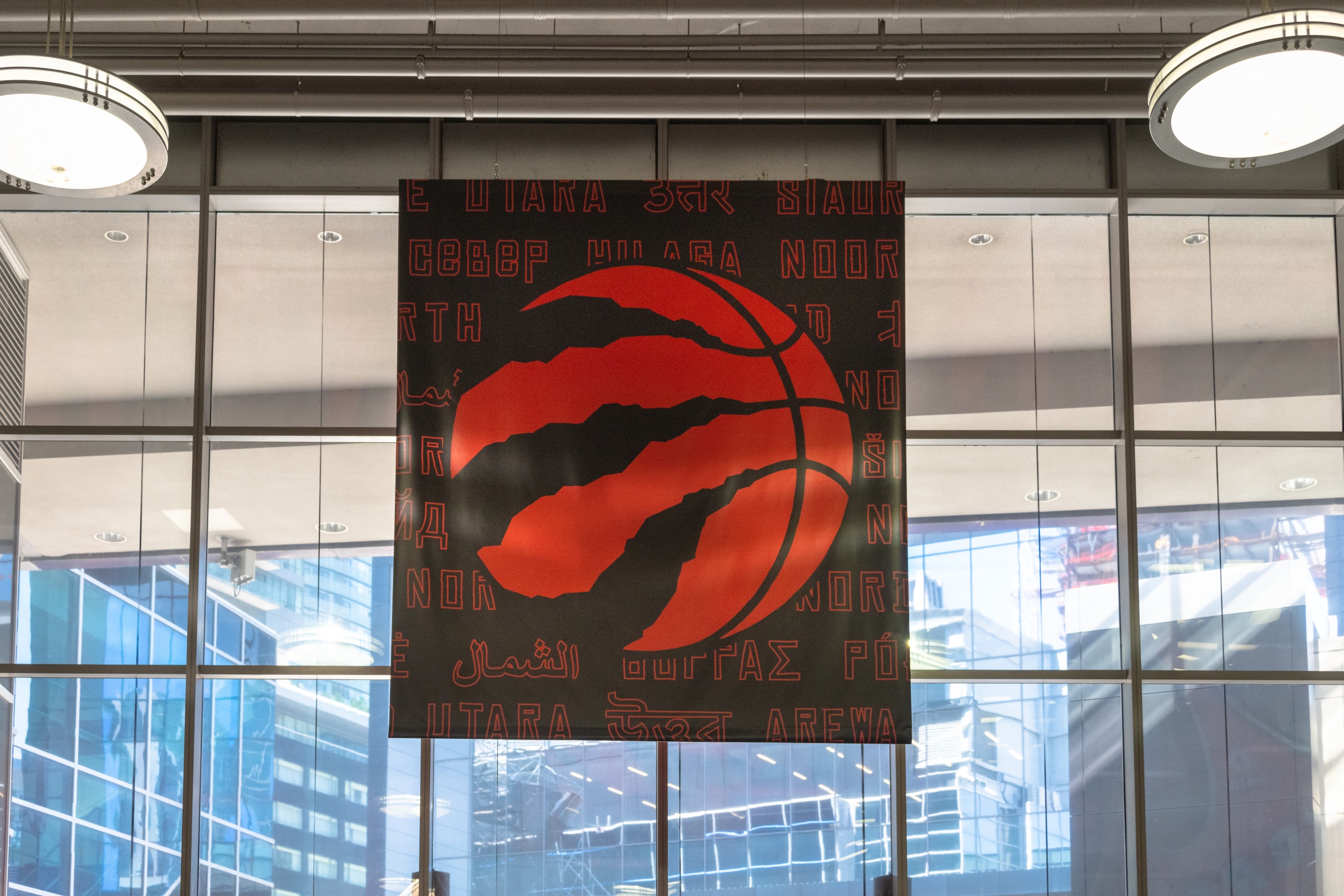 TORONTO, ONTARIO, CANADA - 2019/06/12: Toronto Raptors logo hanging on the wall of a modern skyscraper in the downtown district. Decorations as the Toronto Raptors Basketball team is playing the NBA playoffs for the first time in history. (Photo by Roberto Machado Noa/LightRocket via Getty Images)
