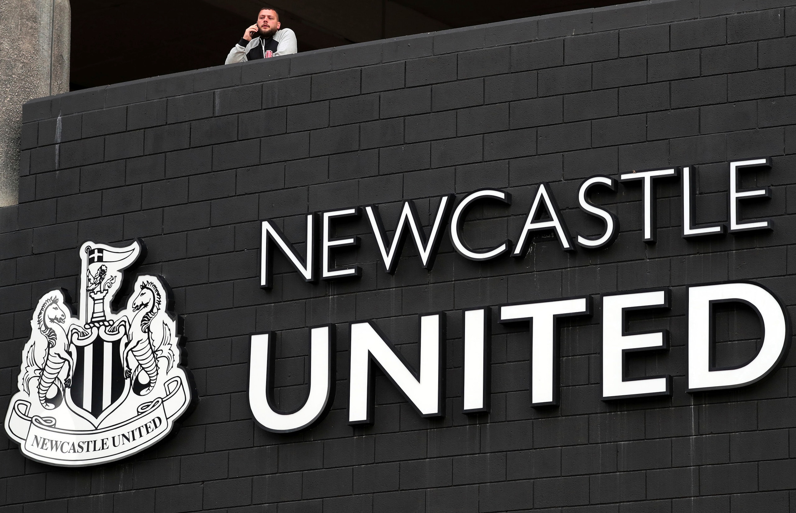 A general view of Newcastle United supporters waiting outside the stadium for news of the latest developments in the sale of the club to the Saudi sovereign wealth fund for 300 million-pound ($408 million) takeover in Newcastle Upon Tyne, England Thursday Oct. 7, 2021. (AP Photo/Scott Heppell)