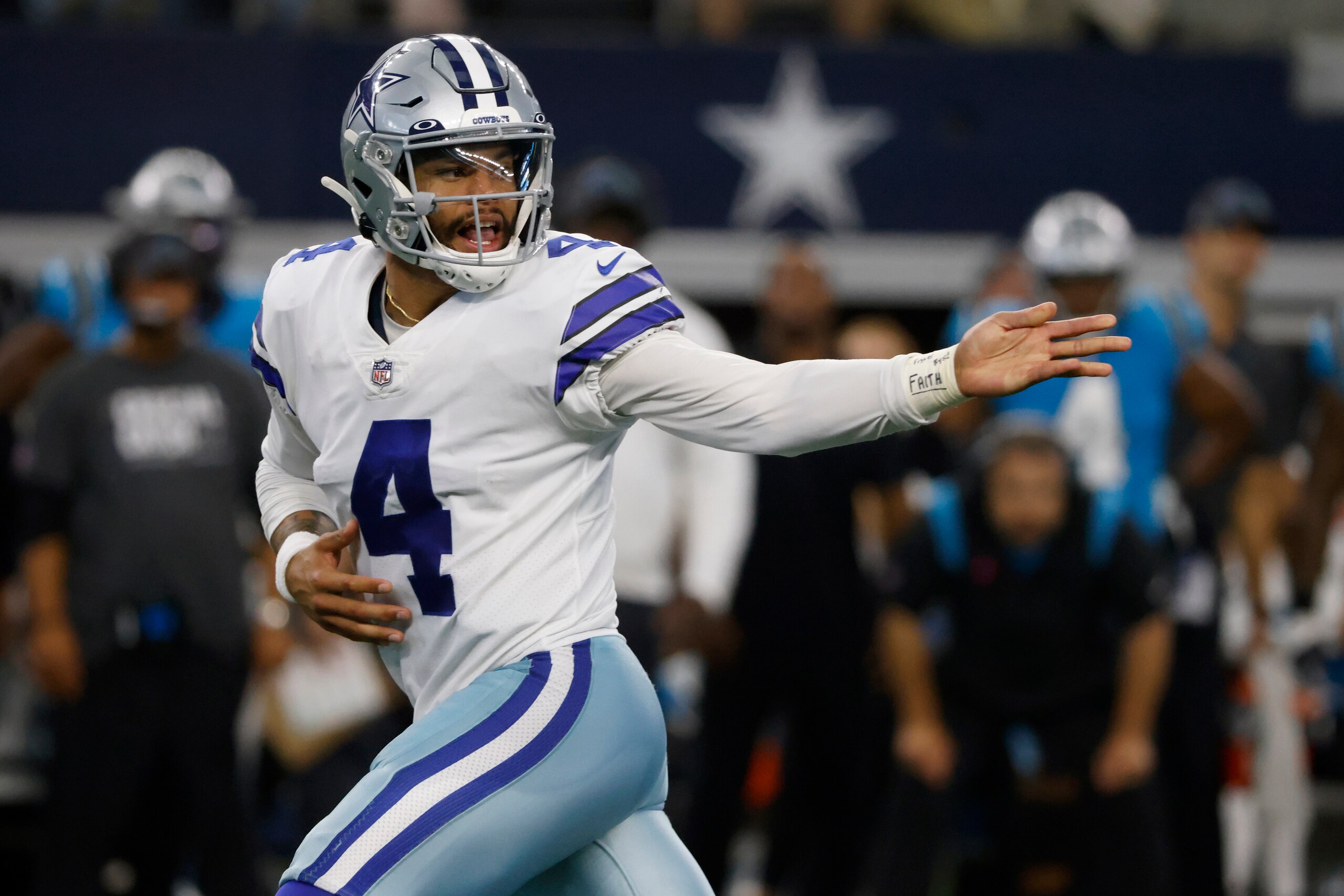 Dallas Cowboys quarterback Dak Prescott (4) hands the ball off against the Carolina Panthers in an NFL football game in Arlington, Texas, Sunday, Oct. 3, 2021. (AP Photo/Ron Jenkins)