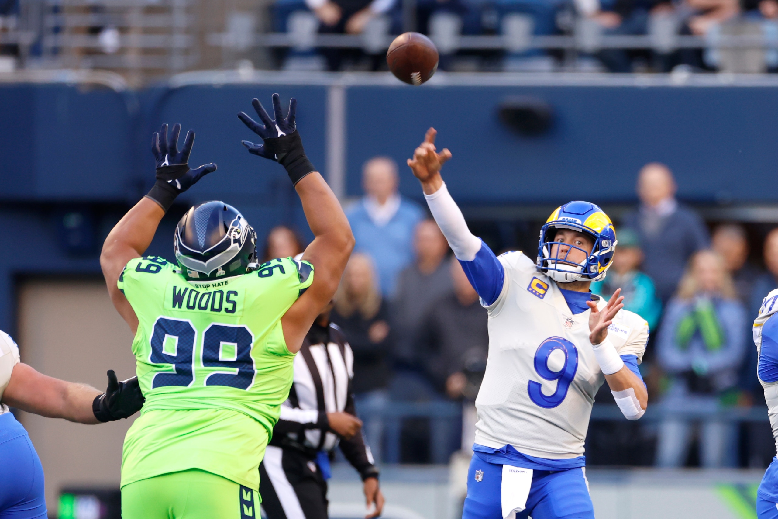Los Angeles Rams quarterback Matthew Stafford (9) passes under pressure from Seattle Seahawks defensive tackle Al Woods (99) during the first half of an NFL football game, Thursday, Oct. 7, 2021, in Seattle. (AP Photo/Craig Mitchelldyer)