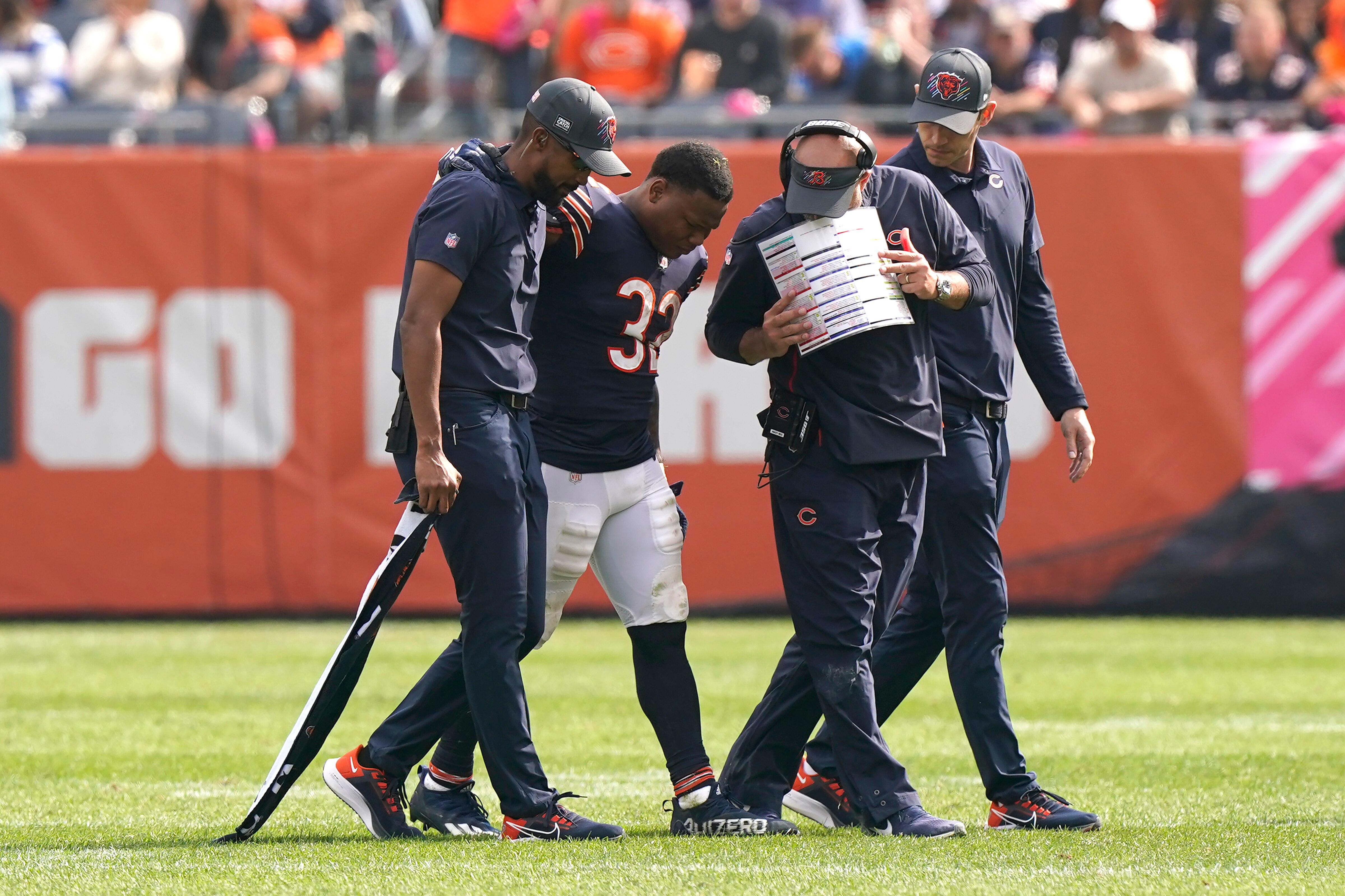 Chicago Bears head coach Matt Nagy, center, examines running back David Montgomery after Montgomery was injured during the second half of an NFL football game against the Detroit Lions Sunday, Oct. 3, 2021, in Chicago. (AP Photo/Nam Y. Huh)