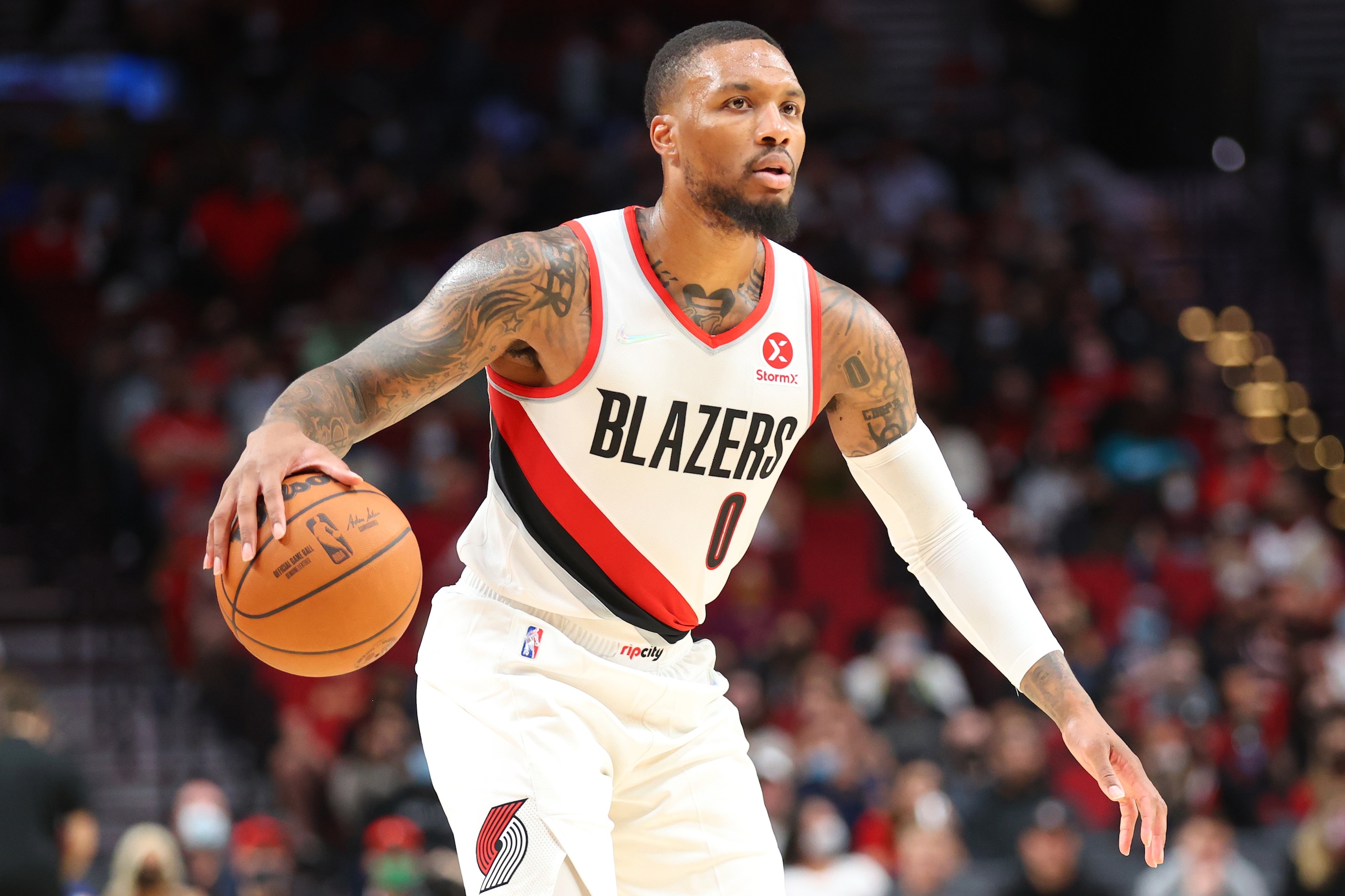 PORTLAND, OREGON - OCTOBER 04: Damian Lillard #0 of the Portland Trail Blazers handles the ball against the Golden State Warriors in the second quarter during the preseason game at Moda Center on October 04, 2021 in Portland, Oregon. NOTE TO USER: User expressly acknowledges and agrees that, by downloading and or using this photograph, User is consenting to the terms and conditions of the Getty Images License Agreement. (Photo by Abbie Parr/Getty Images) PORTLAND, OREGON - OCTOBER 04: Damian Lillard #0 of the Portland Trail Blazers handles the ball against the Golden State Warriors in the second quarter during the preseason game at Moda Center on October 04, 2021 in Portland, Oregon. NOTE TO USER: User expressly acknowledges and agrees that, by downloading and or using this photograph, User is consenting to the terms and conditions of the Getty Images License Agreement. (Photo by Abbie Parr/Getty Images)