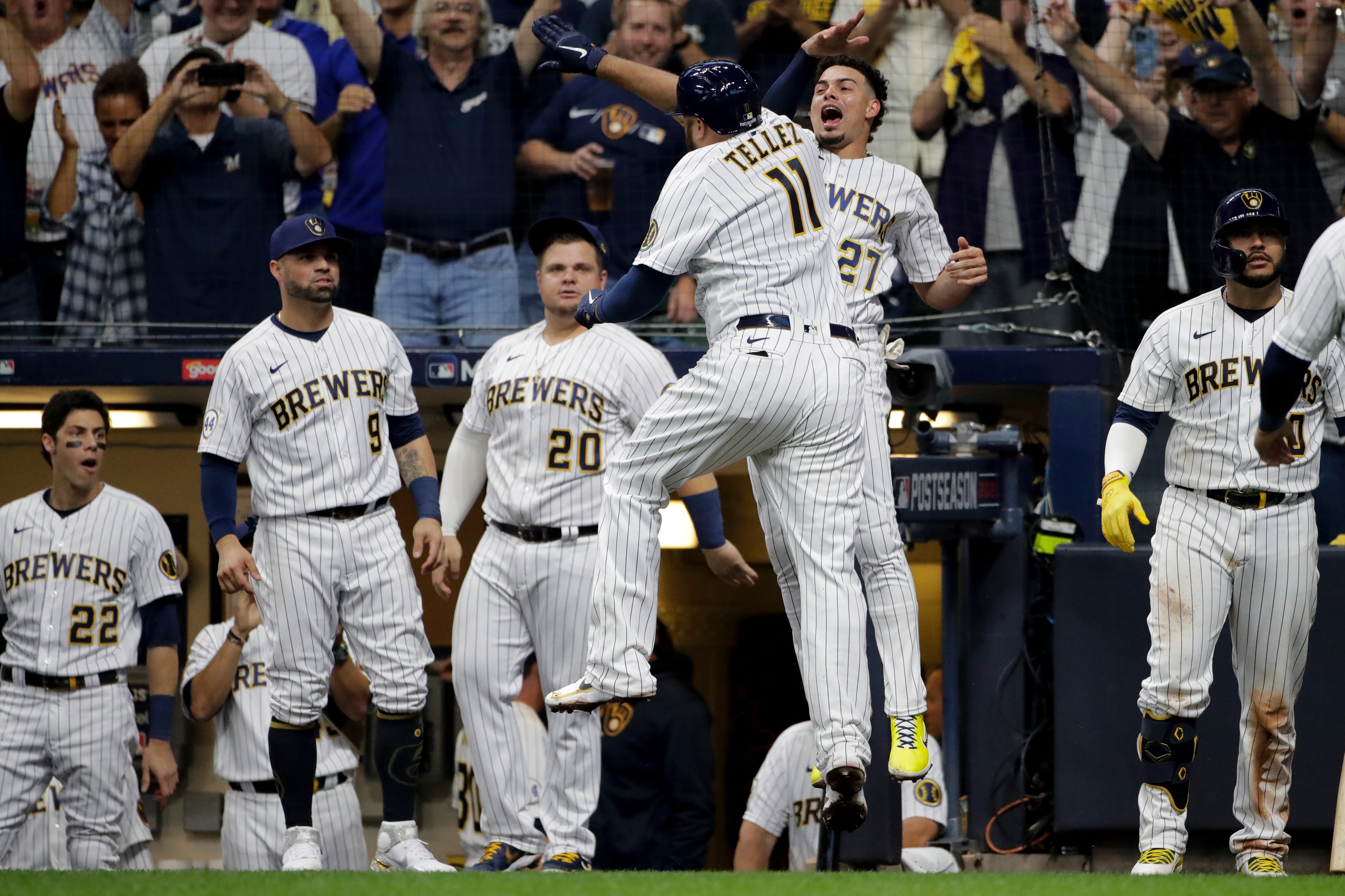 Milwaukee Brewers' Rowdy Tellez celebrates a two-run home run with Willy Adames during the seventh inning in Game 1 of baseball's National League Divisional Series against the Atlanta Braves Friday, Oct. 8, 2021, in Milwaukee.(AP Photo/Aaron Gash)