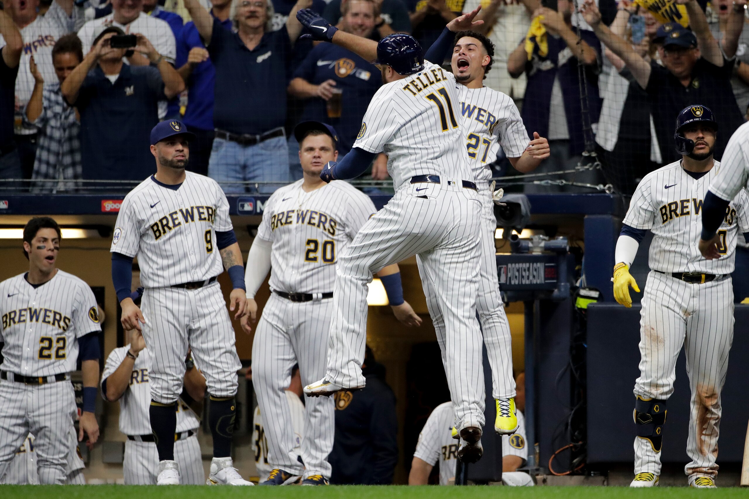 Milwaukee Brewers' Rowdy Tellez celebrates a two-run home run with Willy Adames during the seventh inning in Game 1 of baseball's National League Divisional Series against the Atlanta Braves Friday, Oct. 8, 2021, in Milwaukee.(AP Photo/Aaron Gash)