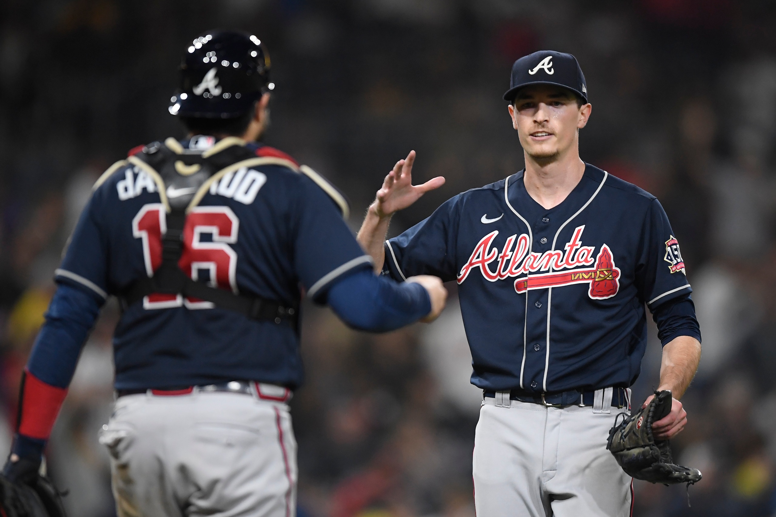 SAN DIEGO, CA - SEPTEMBER 24: Max Fried #54 of the Atlanta Braves, right, is congratulated by Travis d'Arnaud #16 after getting the final out during the ninth inning of a baseball game against the San Diego Padres at Petco Park on September 24, 2021 in San Diego, California. The Braves won 4-0.  (Photo by Denis Poroy/Getty Images)