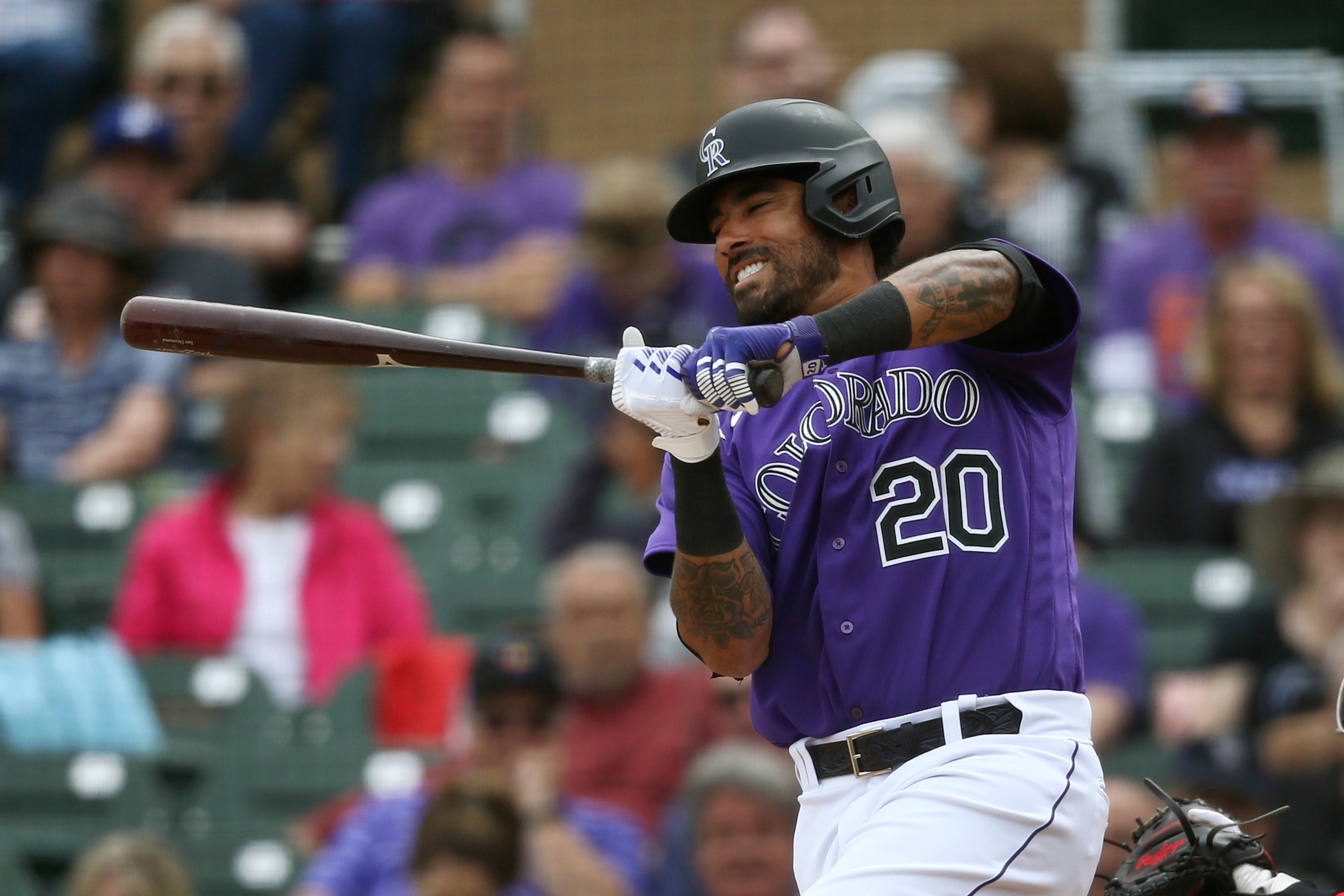 Colorado Rockies' Ian Desmond grimaces on a check swing strike during the fourth inning of a spring training baseball game against the Cincinnati Reds Tuesday, March 10, 2020, in Scottsdale, Ariz. (AP Photo/Ross D. Franklin)