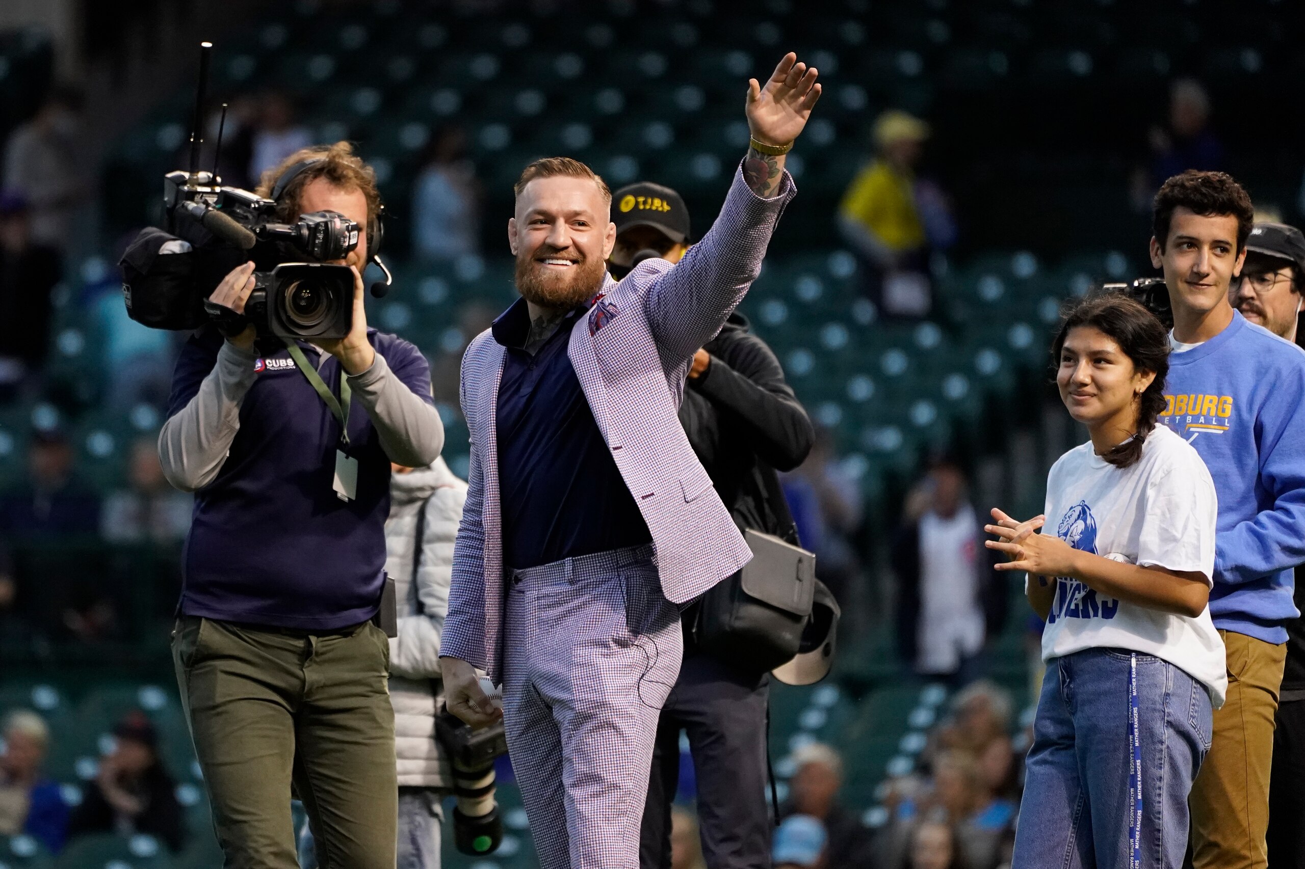 MMA fighter Conor McGregor waves to fans before throwing out a ceremonial first pitch before a baseball game between the Chicago Cubs and the Minnesota Twins Tuesday, Sept. 21, 2021, in Chicago. (AP Photo/Charles Rex Arbogast)