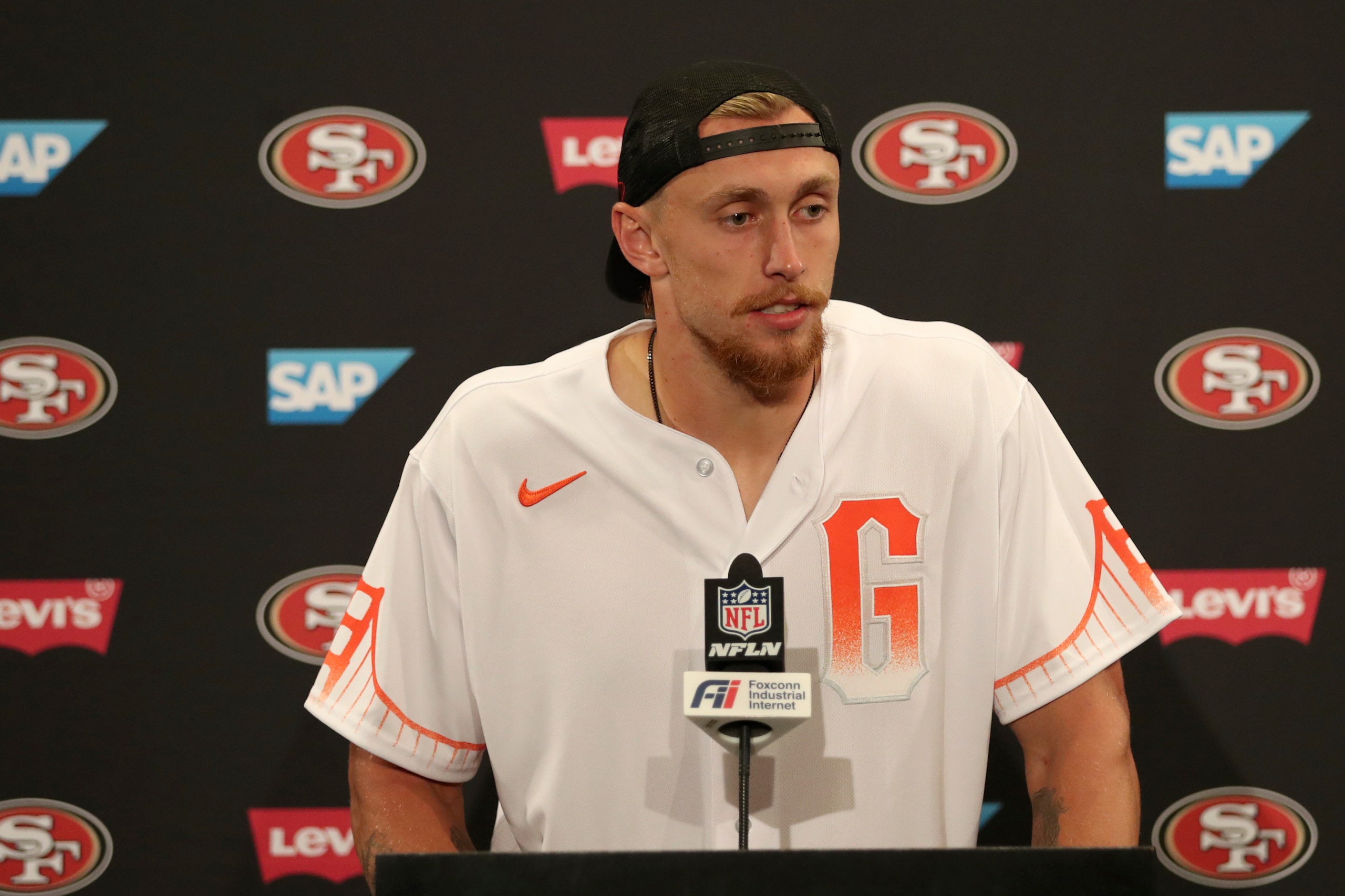 San Francisco 49ers tight end George Kittle wears a San Francisco Giants baseball jersey as he speaks at a news conference after an NFL football game against the Seattle Seahawks in Santa Clara, Calif., Sunday, Oct. 3, 2021. (AP Photo/Jed Jacobsohn) San Francisco 49ers tight end George Kittle wears a San Francisco Giants baseball jersey as he speaks at a news conference after an NFL football game against the Seattle Seahawks in Santa Clara, Calif., Sunday, Oct. 3, 2021. (AP Photo/Jed Jacobsohn)