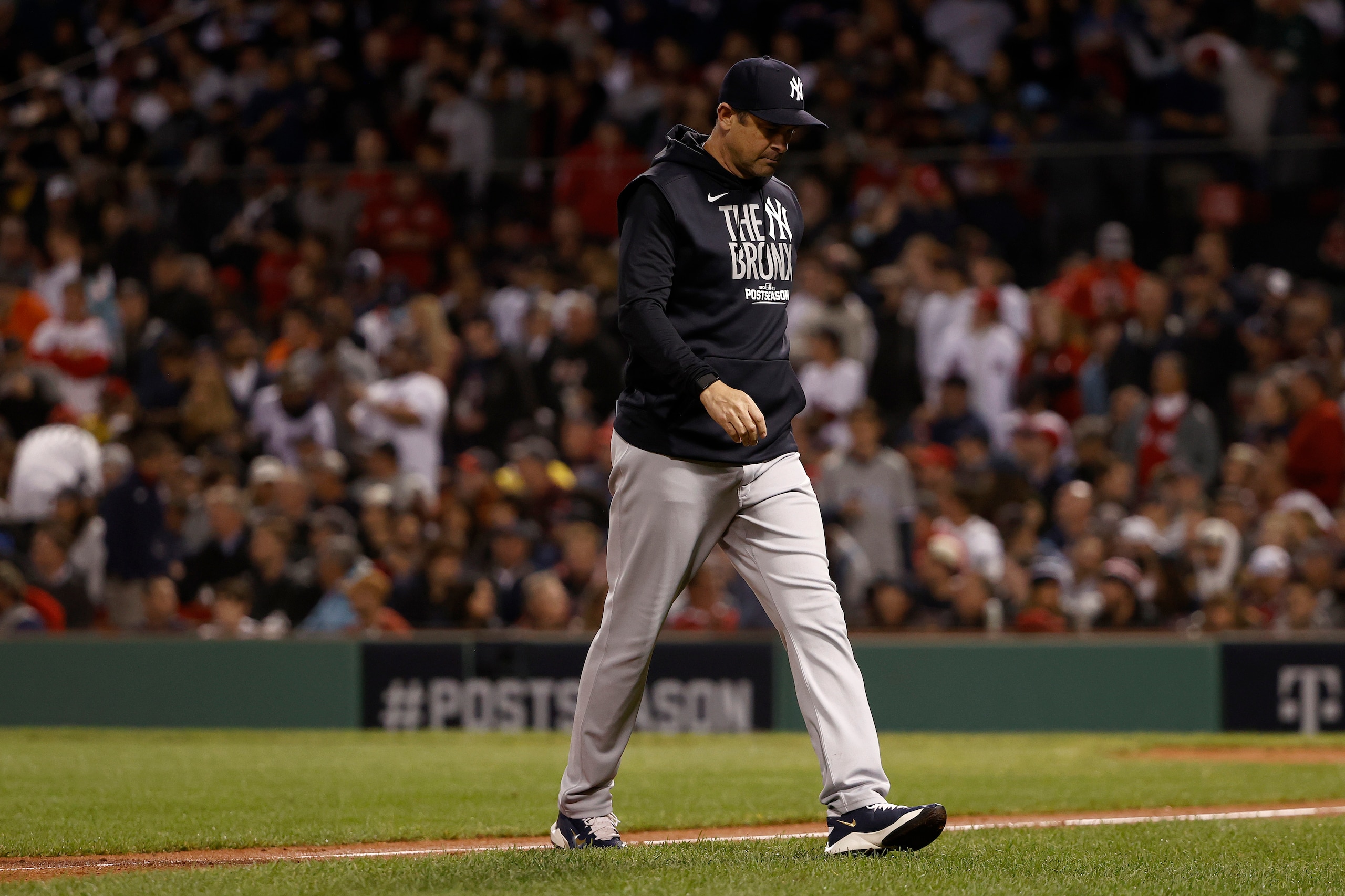 BOSTON, MASSACHUSETTS - OCTOBER 05: Manager Aaron Boone #17 of the New York Yankees walks to the dugout after changing pitchers against the Boston Red Sox during the seventh inning of the American League Wild Card game at Fenway Park on October 05, 2021 in Boston, Massachusetts. (Photo by Winslow Townson/Getty Images)