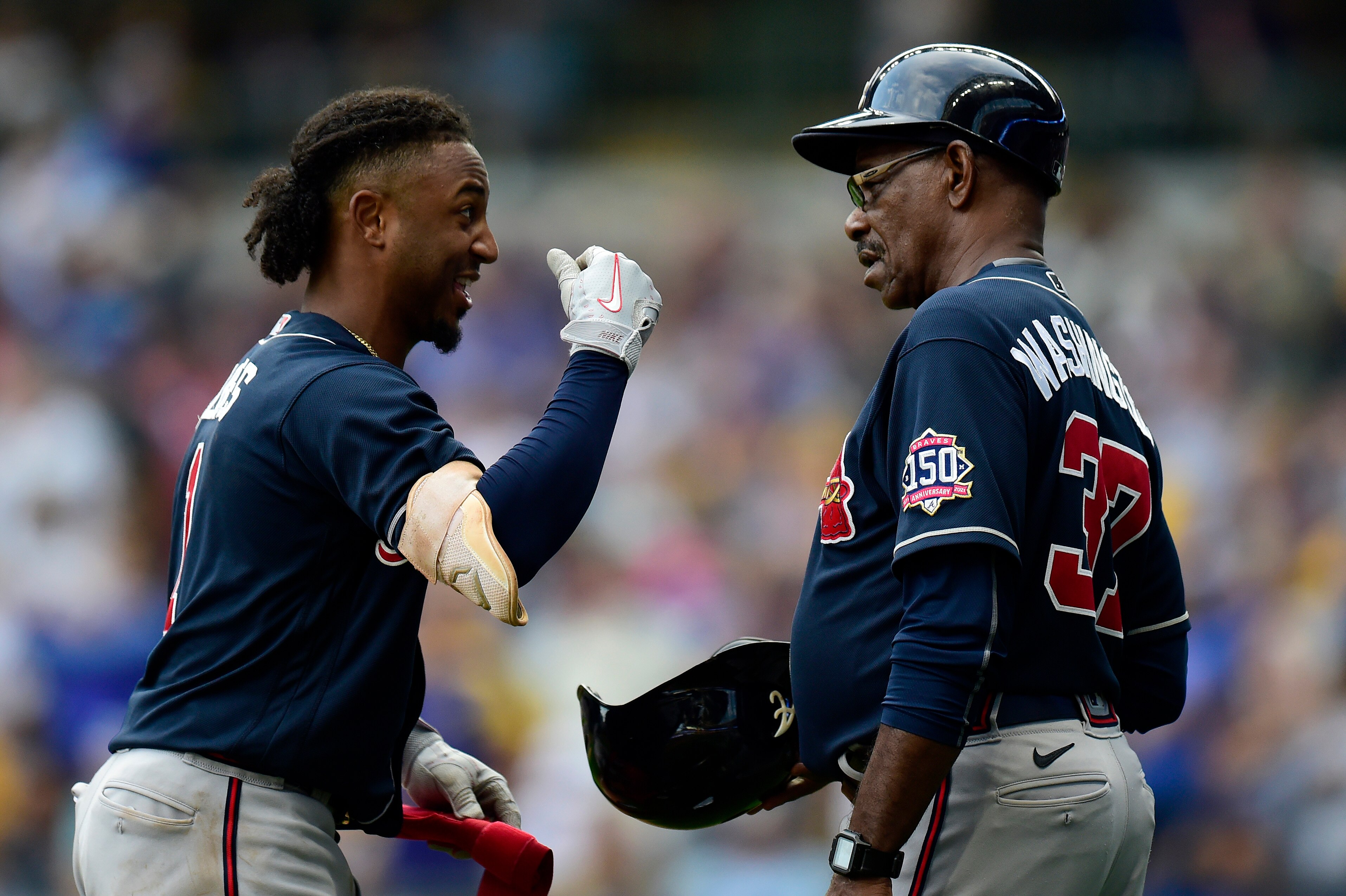 MILWAUKEE, WISCONSIN - OCTOBER 09: Ozzie Albies #1 of the Atlanta Braves talks with Ron Washington #37 of the Atlanta Braves in the third inning during game 2 of the National League Division Series against the Milwaukee Brewers at American Family Field on October 09, 2021 in Milwaukee, Wisconsin. (Photo by Patrick McDermott/Getty Images)