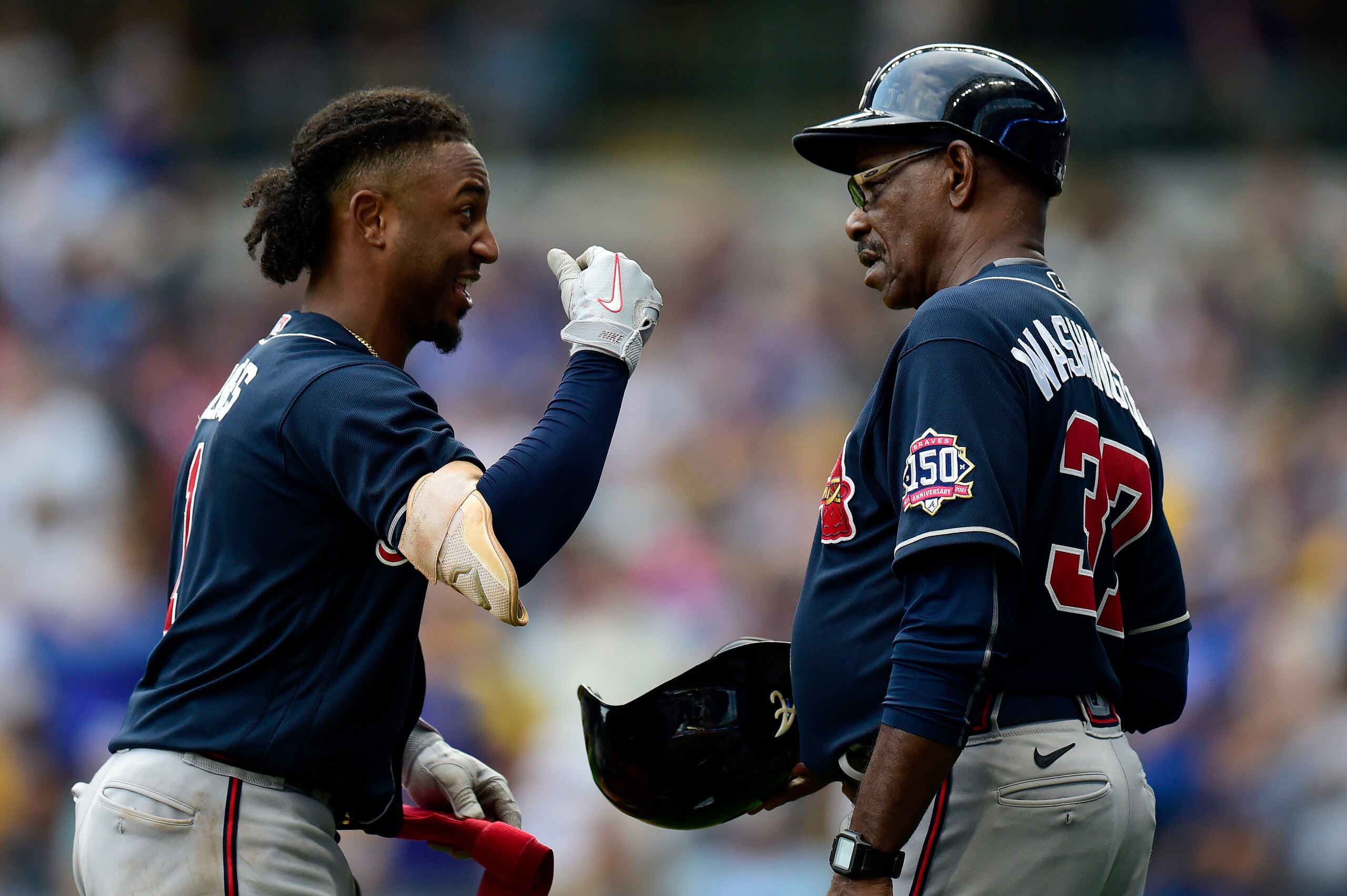 MILWAUKEE, WISCONSIN - OCTOBER 09: Ozzie Albies #1 of the Atlanta Braves talks with Ron Washington #37 of the Atlanta Braves in the third inning during game 2 of the National League Division Series against the Milwaukee Brewers at American Family Field on October 09, 2021 in Milwaukee, Wisconsin. (Photo by Patrick McDermott/Getty Images)