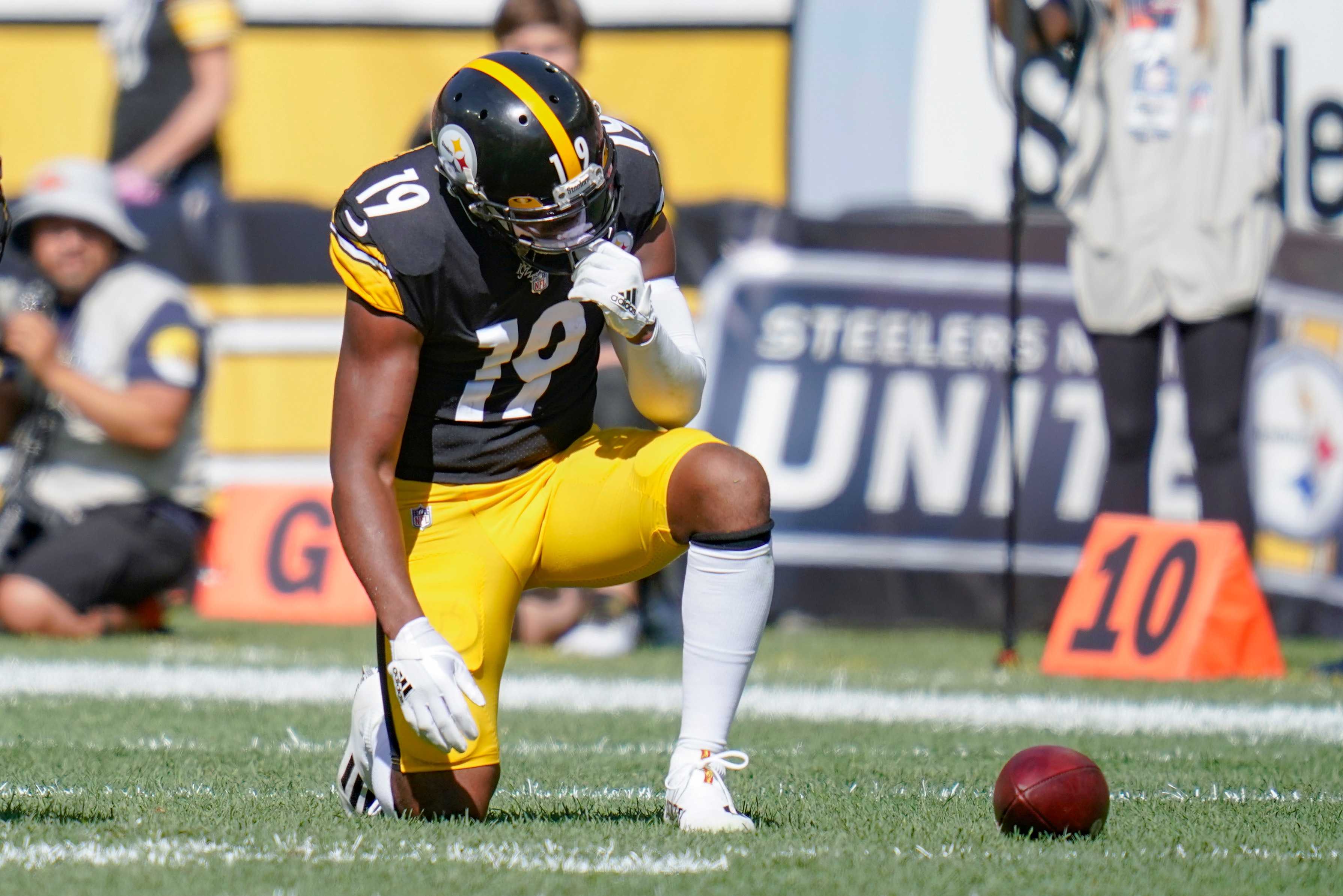Pittsburgh Steelers wide receiver JuJu Smith-Schuster (19) takes a knee after being injured in an NFL football game against the Denver Broncos, Sunday, Oct. 10, 2021, in Pittsburgh. (AP Photo/Keith Srakocic)
