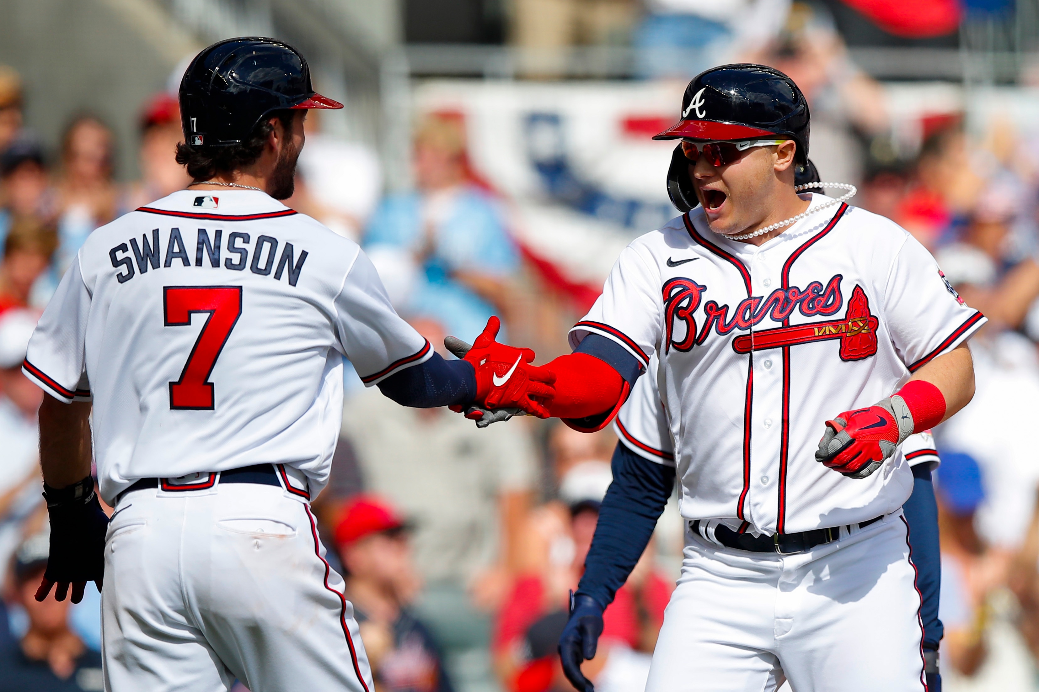 ATLANTA, GEORGIA - OCTOBER 11: Joc Pederson #22 of the Atlanta Braves high fives Dansby Swanson #7 after hitting a three run home during the fifth inning against the Milwaukee Brewers in game 3 of the National League Division Series at Truist Park on October 11, 2021 in Atlanta, Georgia. (Photo by Todd Kirkland/Getty Images)