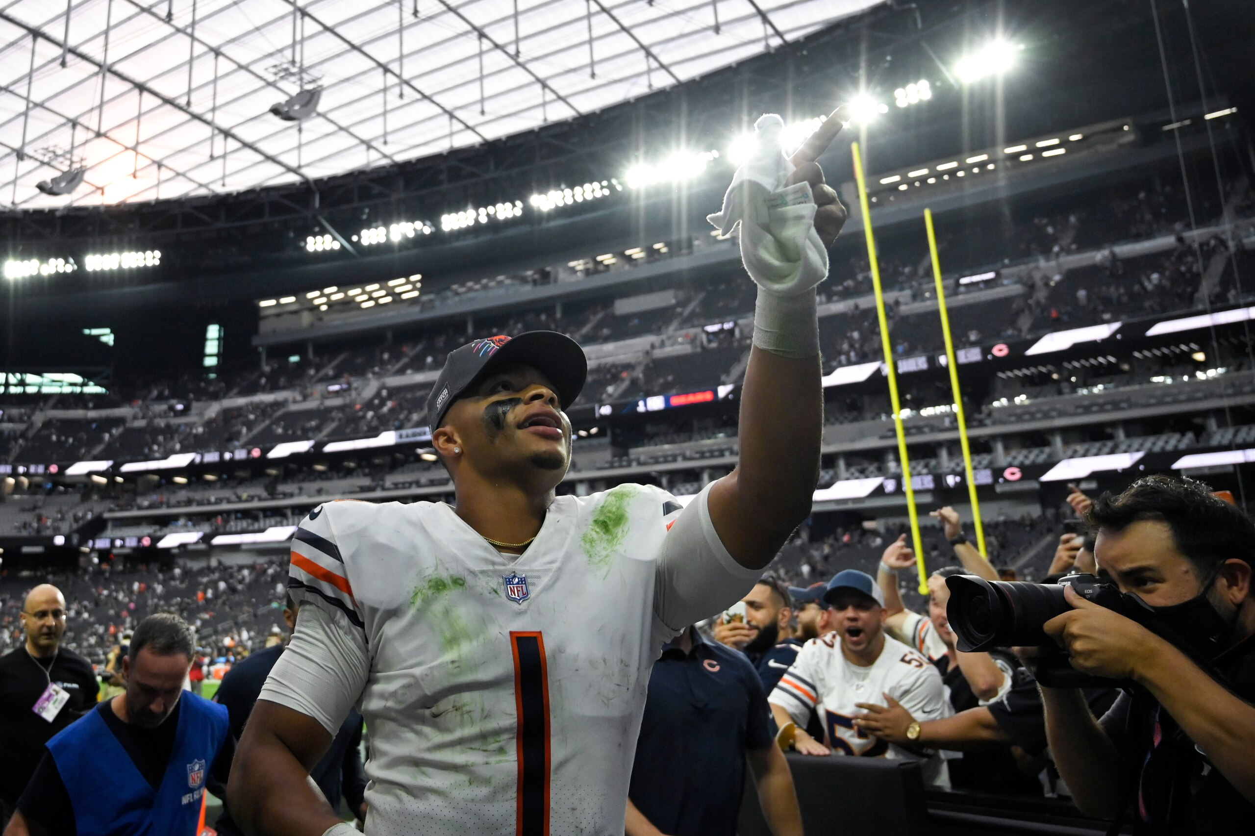 Chicago Bears quarterback Justin Fields (1) runs off the field after the Chicago Bears defeated the Las Vegas Raiders in an NFL football game, Sunday, Oct. 10, 2021, in Las Vegas. (AP Photo/David Becker)