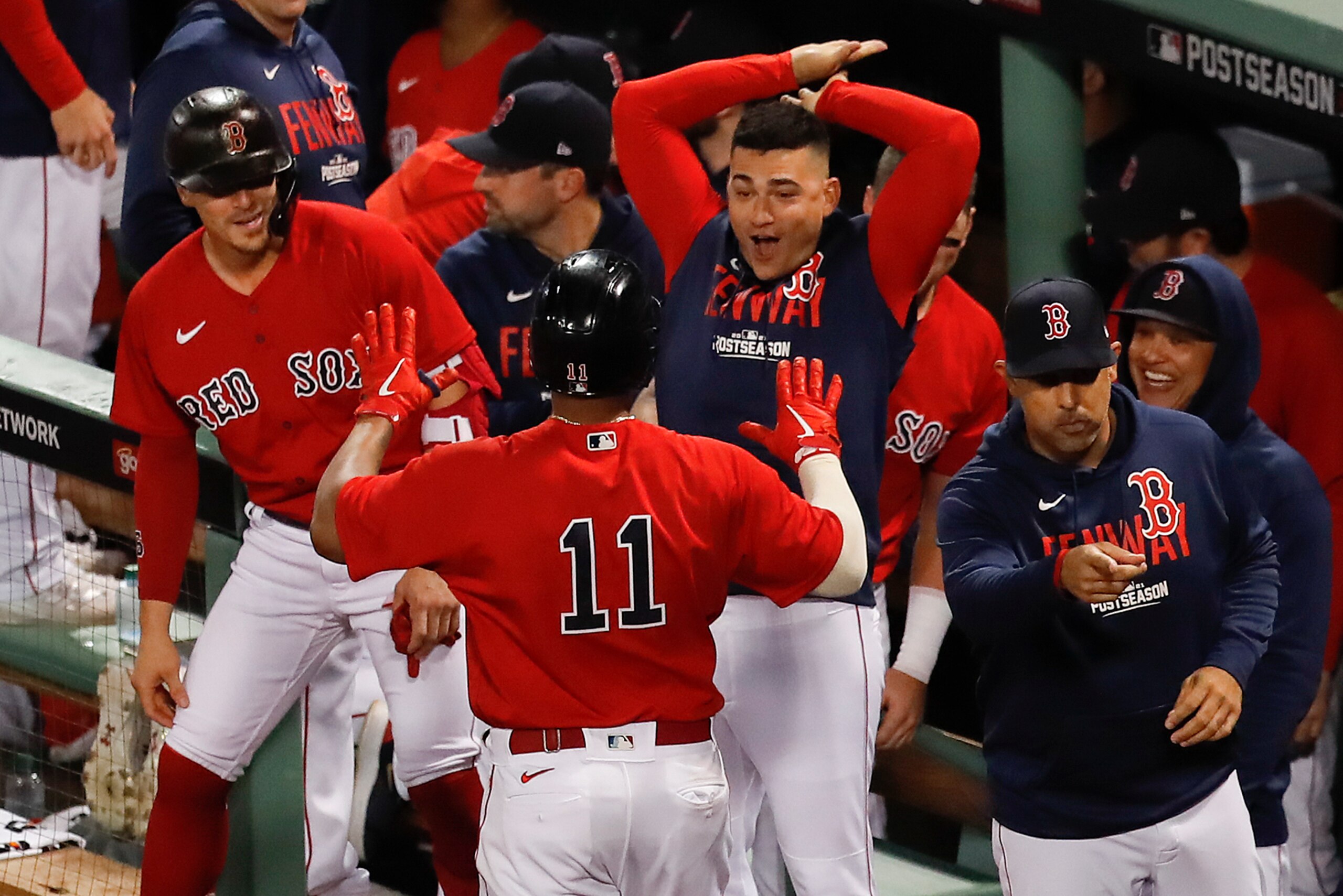 Boston Red Sox Rafael Devers (11) is congratulated by teammates after hitting a three-run home run during the third inning against the Tampa Bay Rays during Game 4 of a baseball American League Division Series, Monday, Oct. 11, 2021, in Boston. (AP Photo/Michael Dwyer)