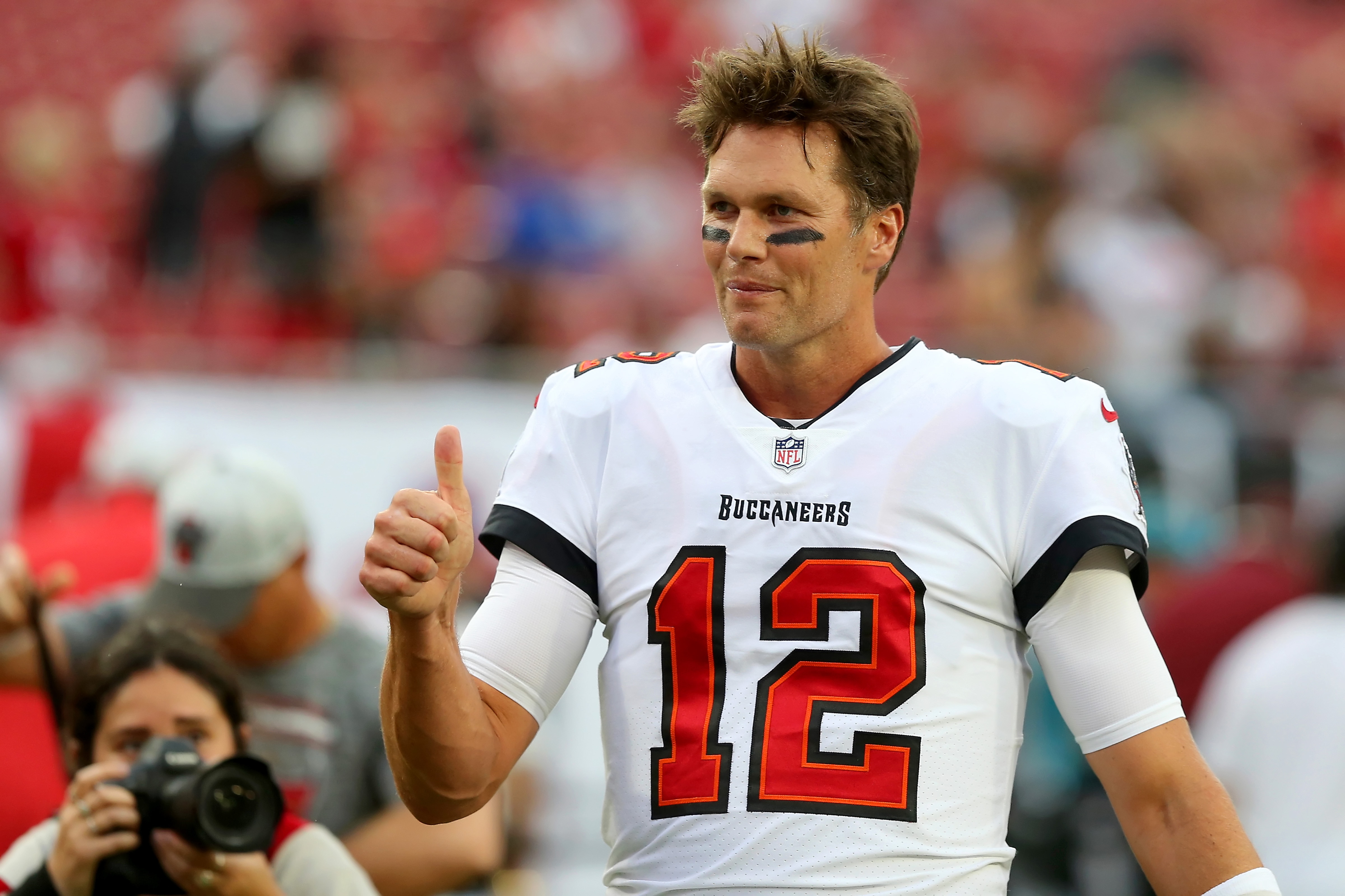 TAMPA, FL - AUGUST 14: Tom Brady (12) of the Buccaneers gives a thumbs up to fans in the south end zone before the preseason game between the Cincinnati Bengals and the Tampa Bay Buccaneers on August 14, 2021 at Raymond James Stadium in Tampa, Florida. (Photo by Cliff Welch/Icon Sportswire via Getty Images)