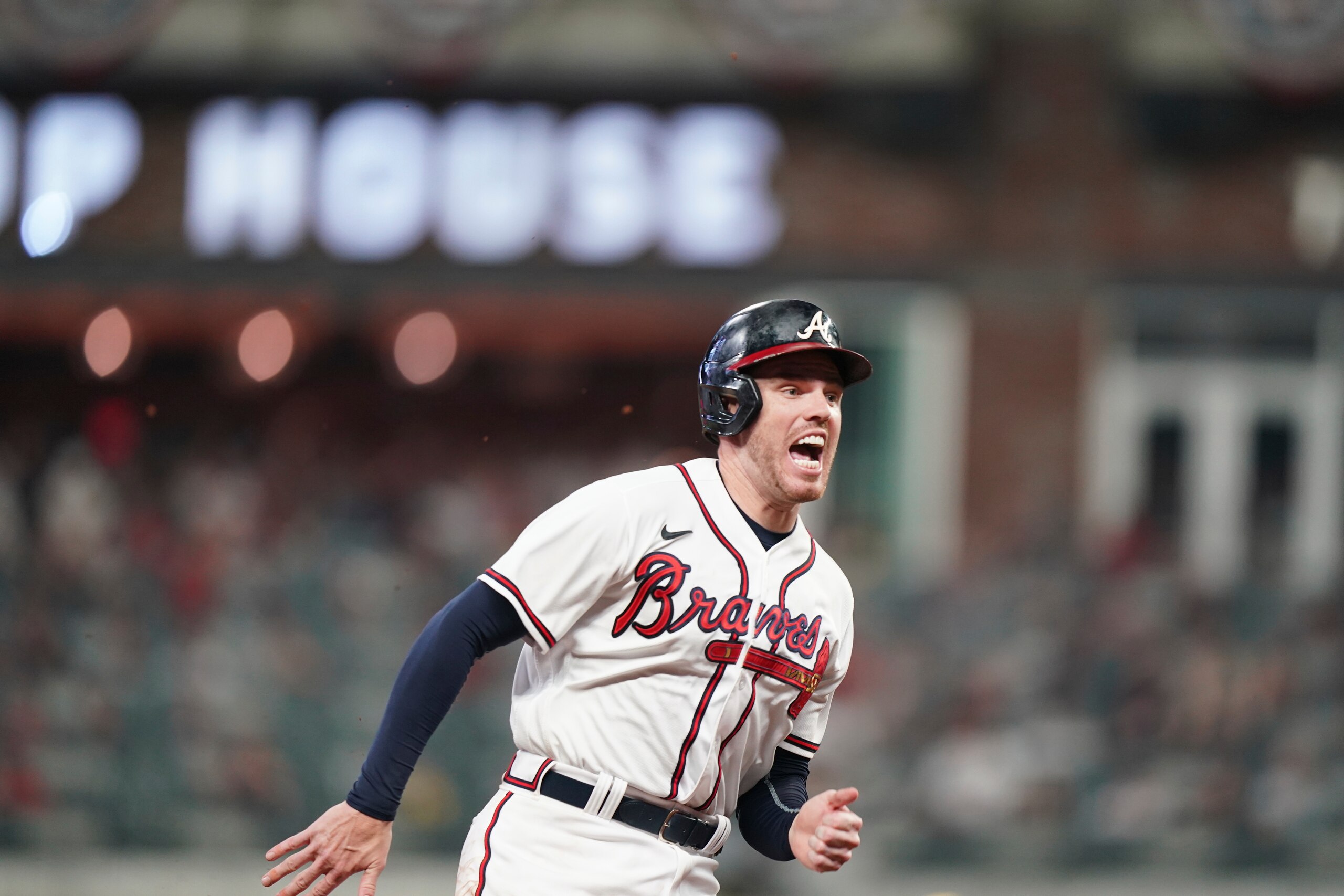 Atlanta Braves' Freddie Freeman (5) runs to third base after a Atlanta Braves' Ozzie Albies single against the Milwaukee Brewers during the sixth inning of Game 4 of a baseball National League Division Series, Tuesday, Oct. 12, 2021, in Atlanta. (AP Photo/Brynn Anderson)