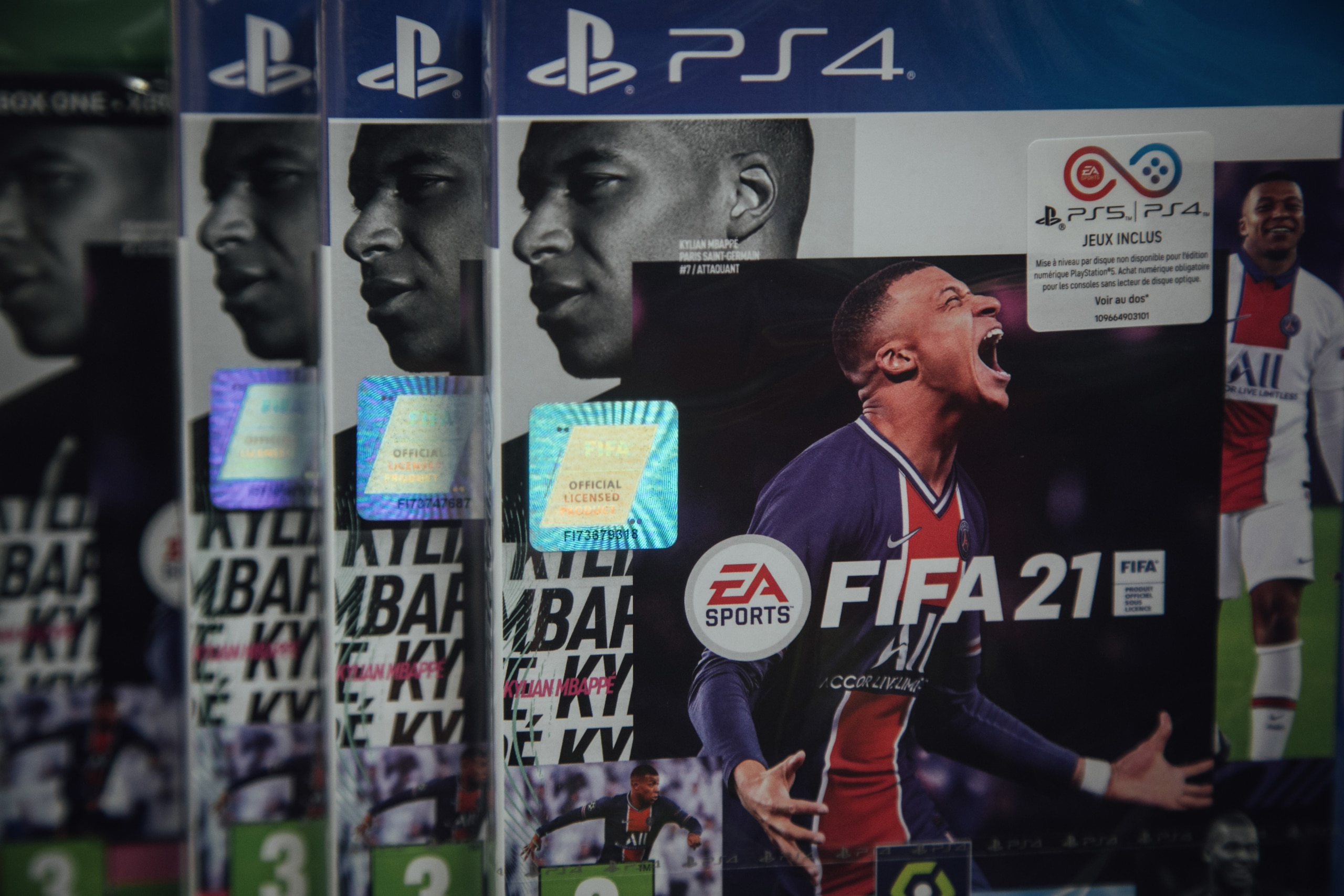 Copies of the FIFA 2021 soccer game, produced by Electronic Artists Inc., for the PlayStation 4 (PS4) console at a video games store in Paris, France, on Thursday, June 17, 2021. The reinstatement of Cyberpunk 2077 to the PlayStation store will help CD Projekt SA with the marketing of games series but may not make much of a difference for its bottom line until a new version of the futuristic role-playing game is ready, according to BOS Bank SA analyst Tomasz Rodak. Photographer: Cyril Marcilhacy/Bloomberg via Getty Images