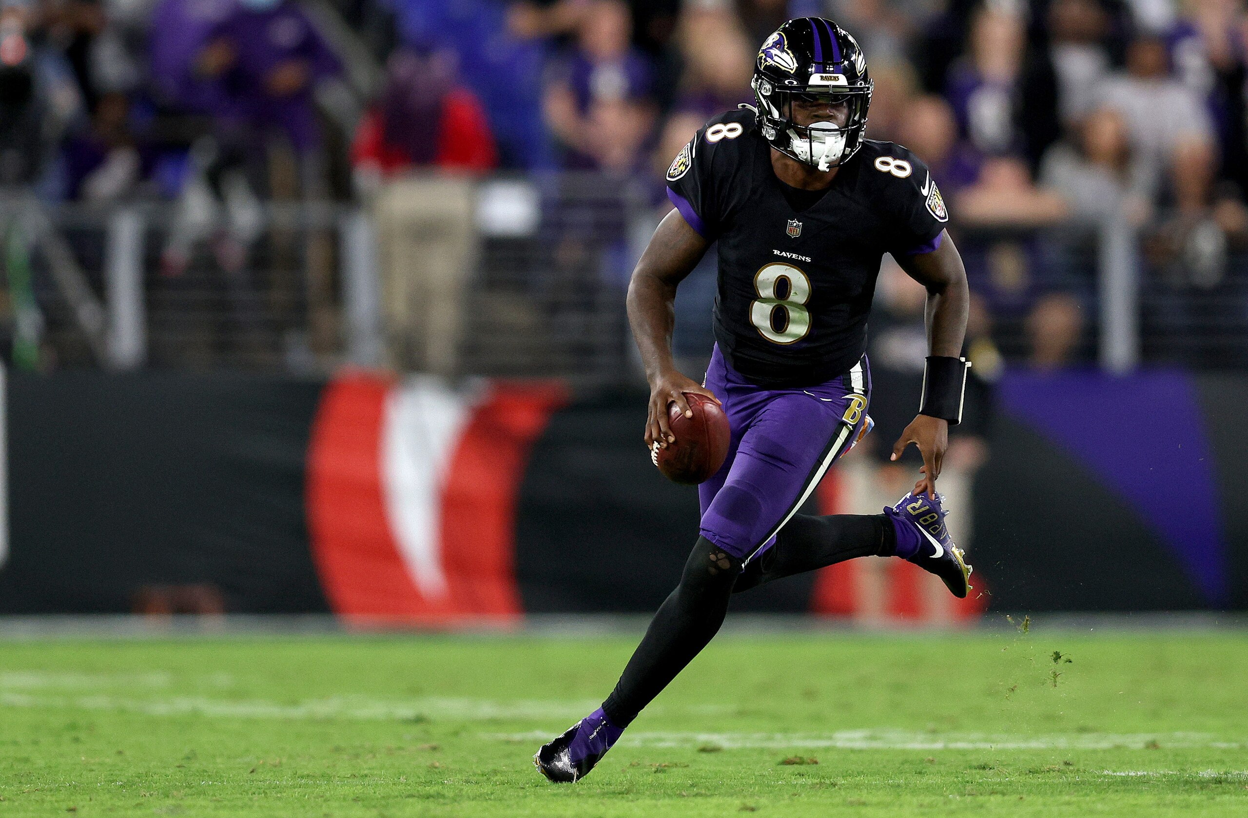 BALTIMORE, MARYLAND - OCTOBER 11: Lamar Jackson #8 of the Baltimore Ravens rushes during the fourth quarter in a game against the Indianapolis Colts at M&T Bank Stadium on October 11, 2021 in Baltimore, Maryland. (Photo by Patrick Smith/Getty Images)