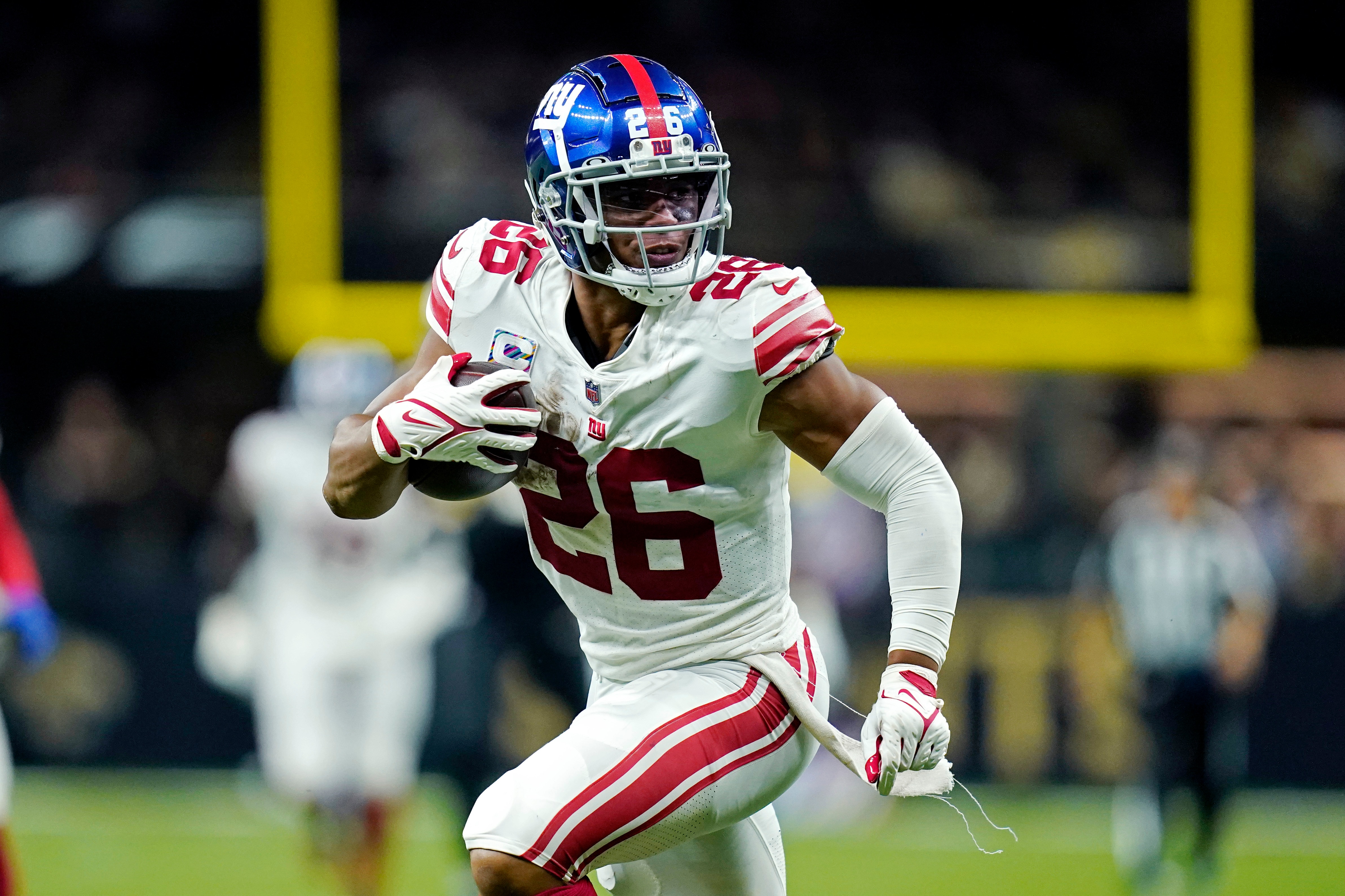 New York Giants running back Saquon Barkley (26) carries in the second half of an NFL football game against the New Orleans Saints in New Orleans, Sunday, Oct. 3, 2021. The Giants won in overtime 27-21. (AP Photo/Brett Duke)