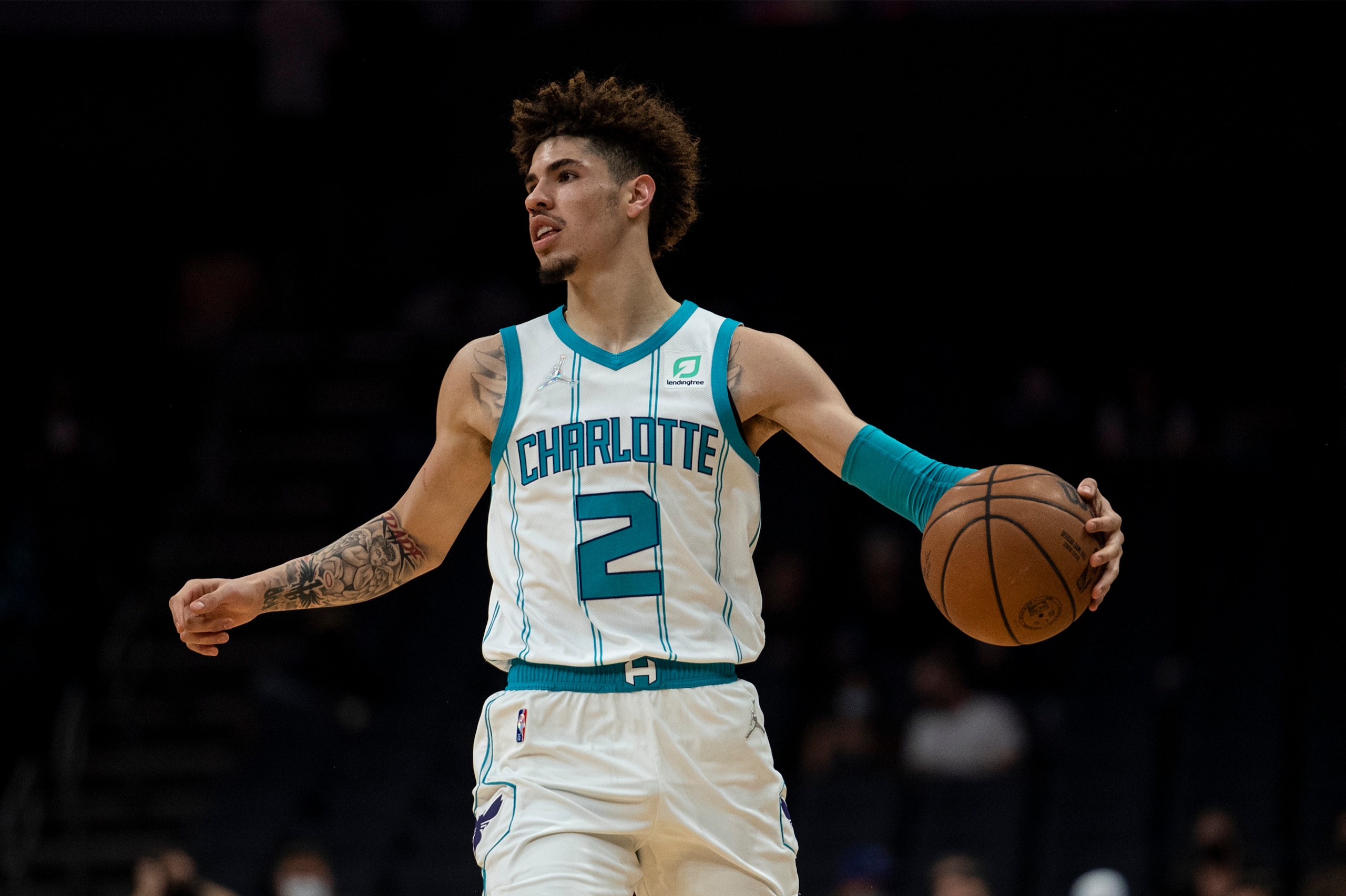 Charlotte Hornets guard LaMelo Ball (2) dribbles the ball during the first half of the team's NBA preseason basketball game against Dallas Mavericks, Wednesday, Oct. 13, 2021, in Charlotte, N.C. (AP Photo/Matt Kelley)