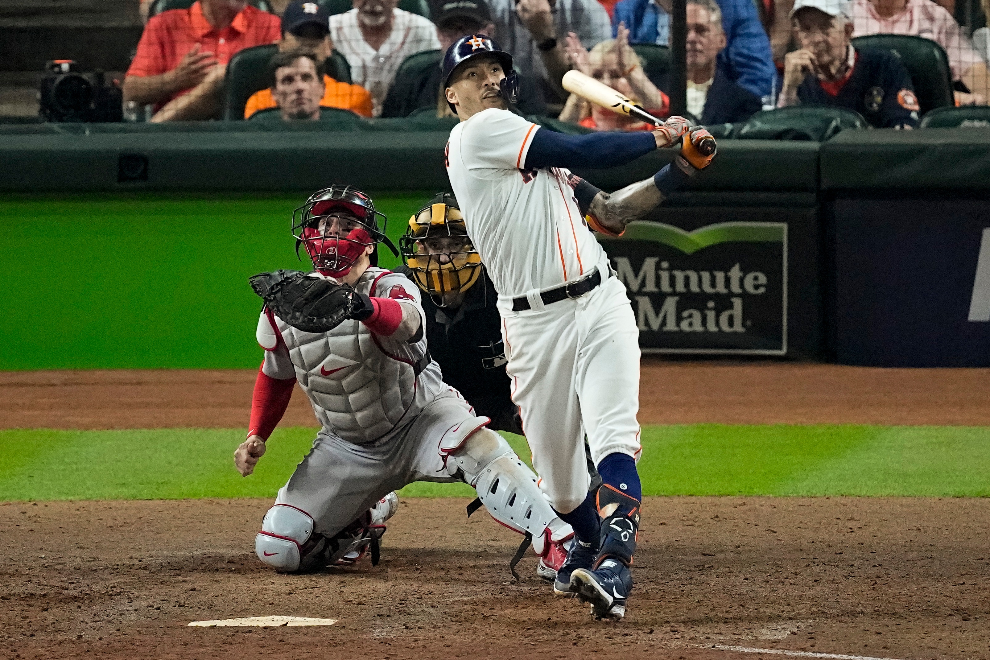 Houston Astros' Carlos Correa hits a home run against the Boston Red Sox during the seventh inning in Game 1 of baseball's American League Championship Series Friday, Oct. 15, 2021, in Houston. (AP Photo/Sue Ogrocki)