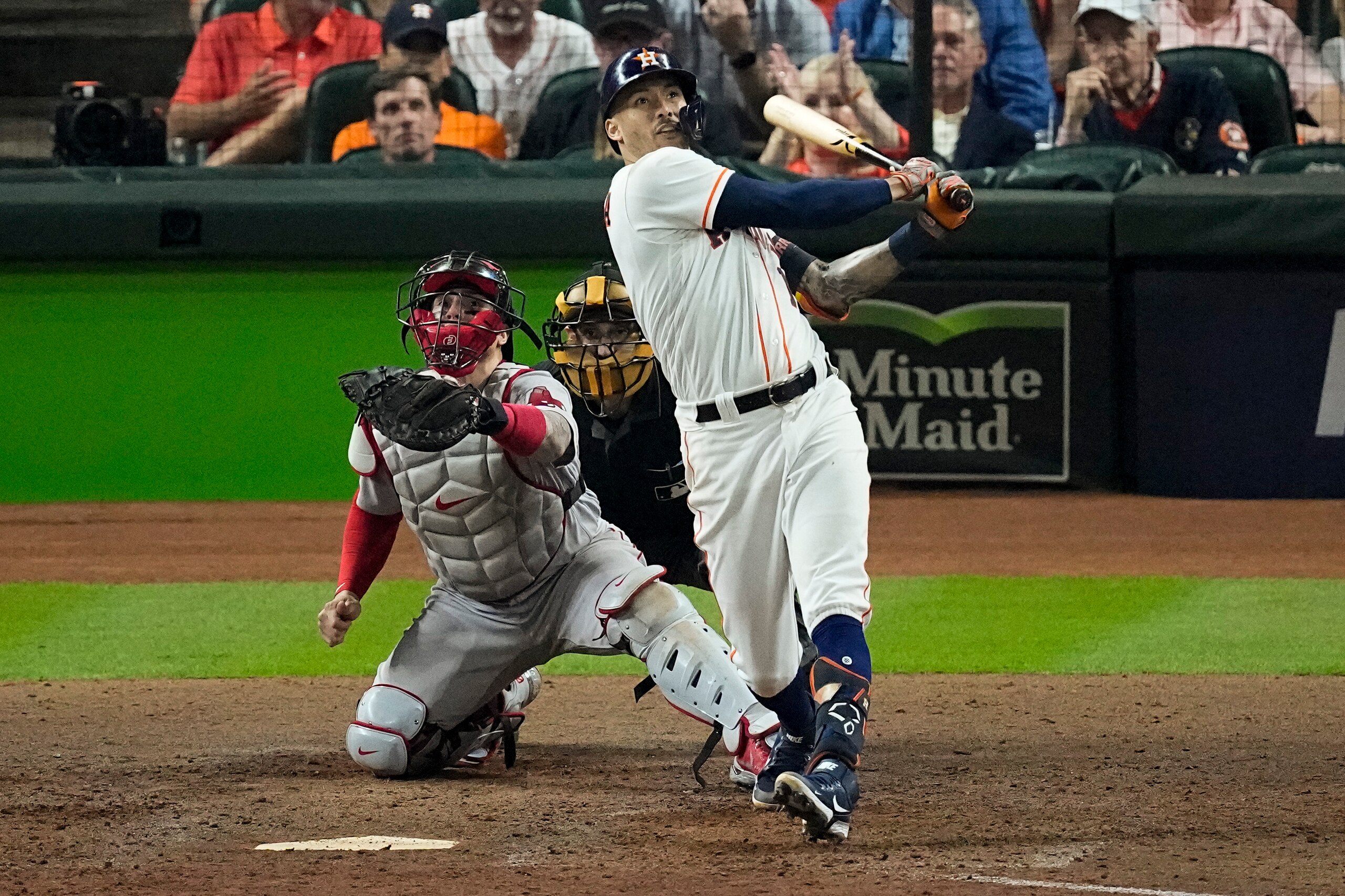 Houston Astros' Carlos Correa hits a home run against the Boston Red Sox during the seventh inning in Game 1 of baseball's American League Championship Series Friday, Oct. 15, 2021, in Houston. (AP Photo/Sue Ogrocki)