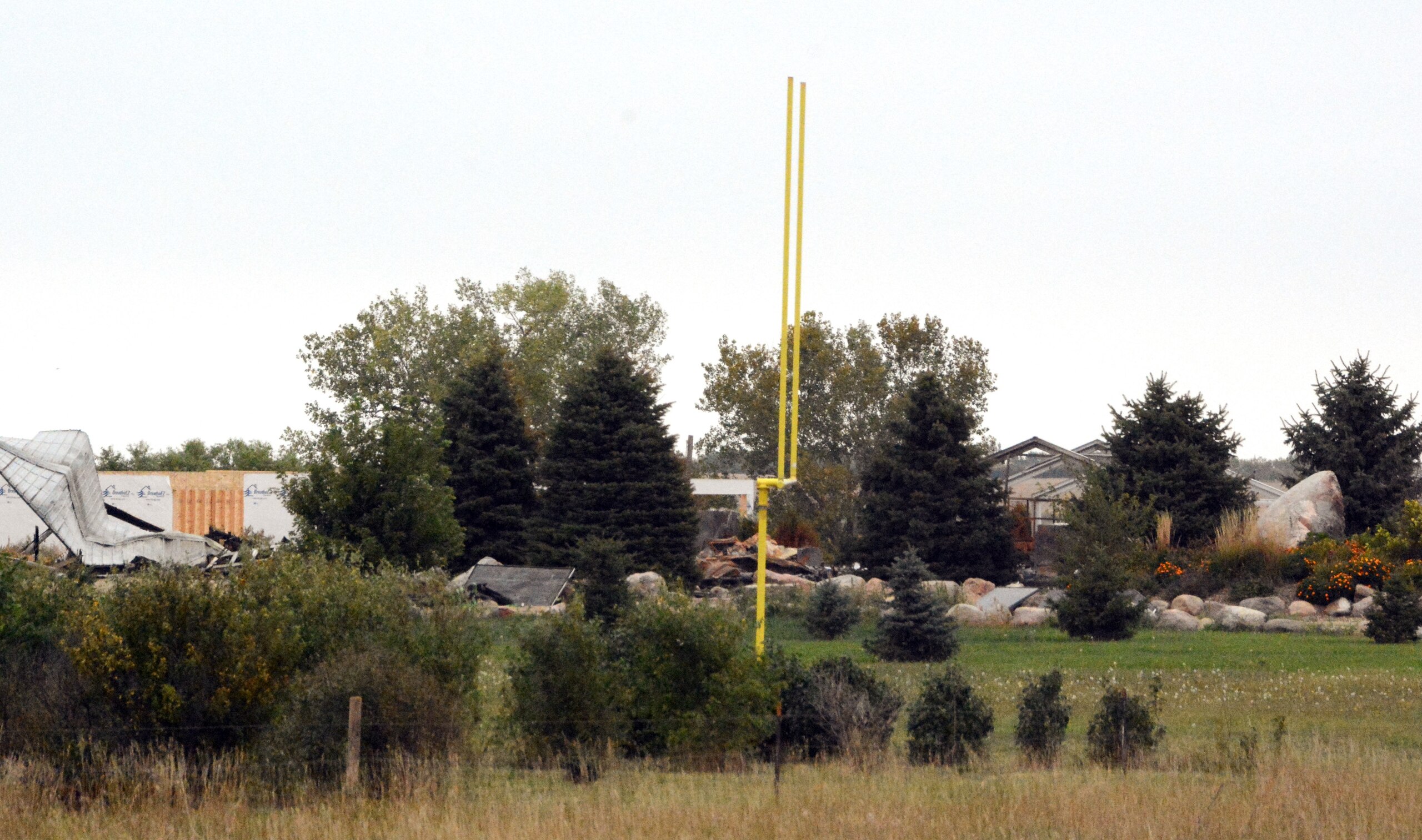 A football goalpost stands in front of the burned house of the Westerhuis family, Tuesday, Sept. 22, 2015, near Platte, S.D. Authorities believe a man fatally shot his wife and four children, set their house on fire, then turned the shotgun on himself, the state's attorney general's office said Tuesday. (AP Photo/Dirk Lammers)