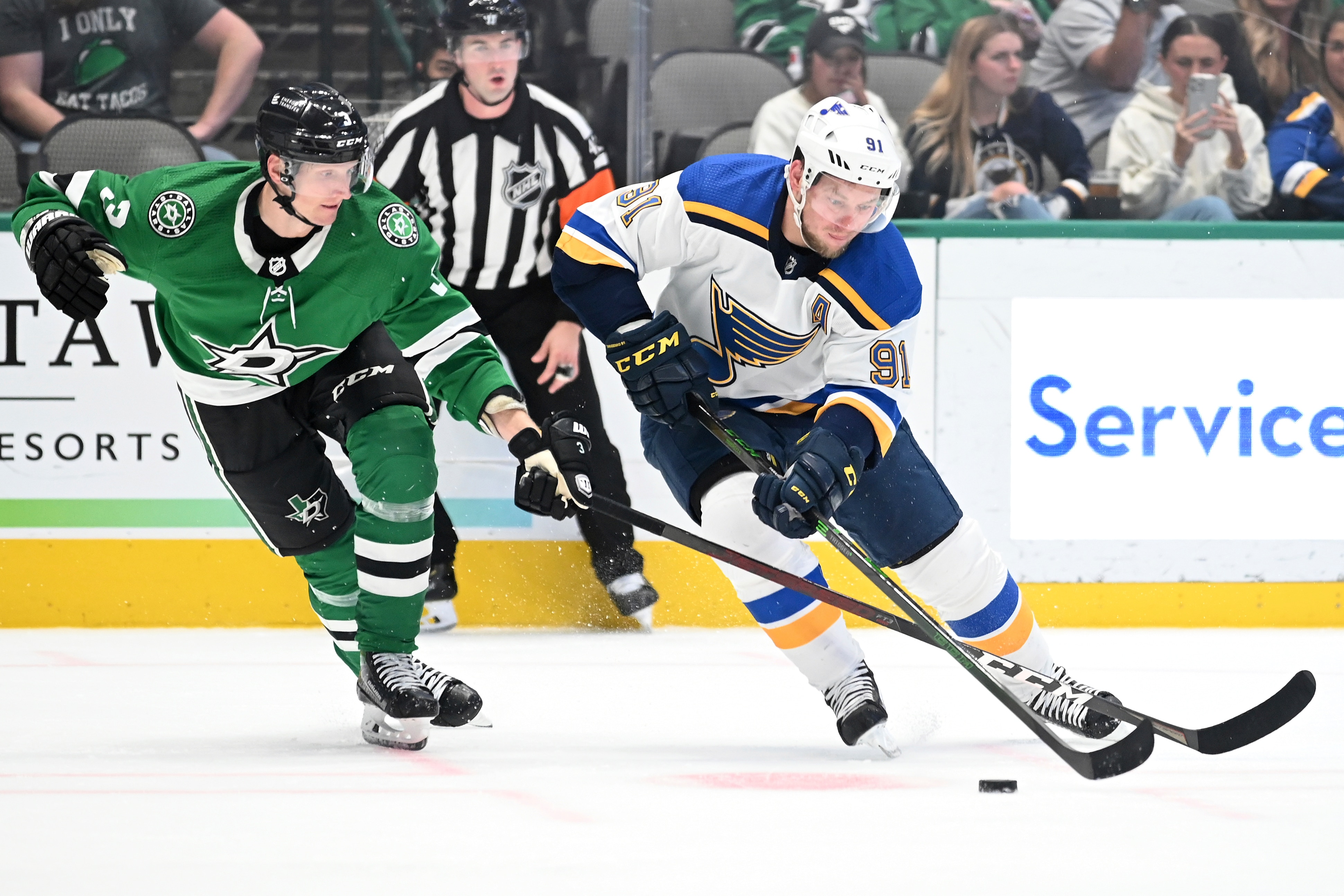 St. Louis Blues right wing Vladimir Tarasenko (91) tries to control the puck in front of Dallas Stars defenseman John Klingberg (3) in the second period during a preseason NHL hockey game in Dallas, Tuesday, Oct. 5, 2021. (AP Photo/Matt Strasen)