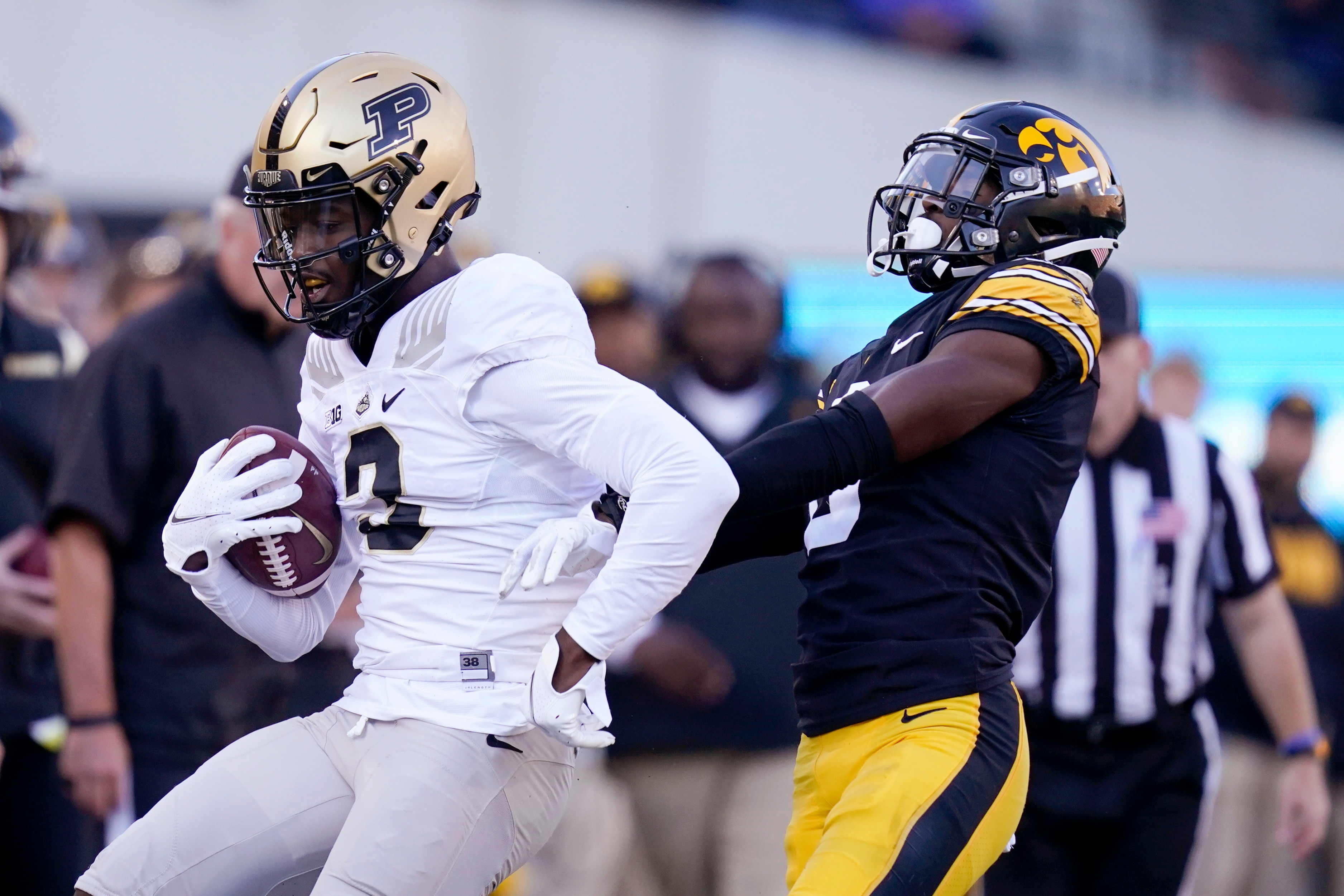 Purdue wide receiver David Bell (3) runs from Iowa defensive back Matt Hankins, right, after catching a pass during the second half of an NCAA college football game, Saturday, Oct. 16, 2021, in Iowa City, Iowa. Purdue won 24-7. (AP Photo/Charlie Neibergall)