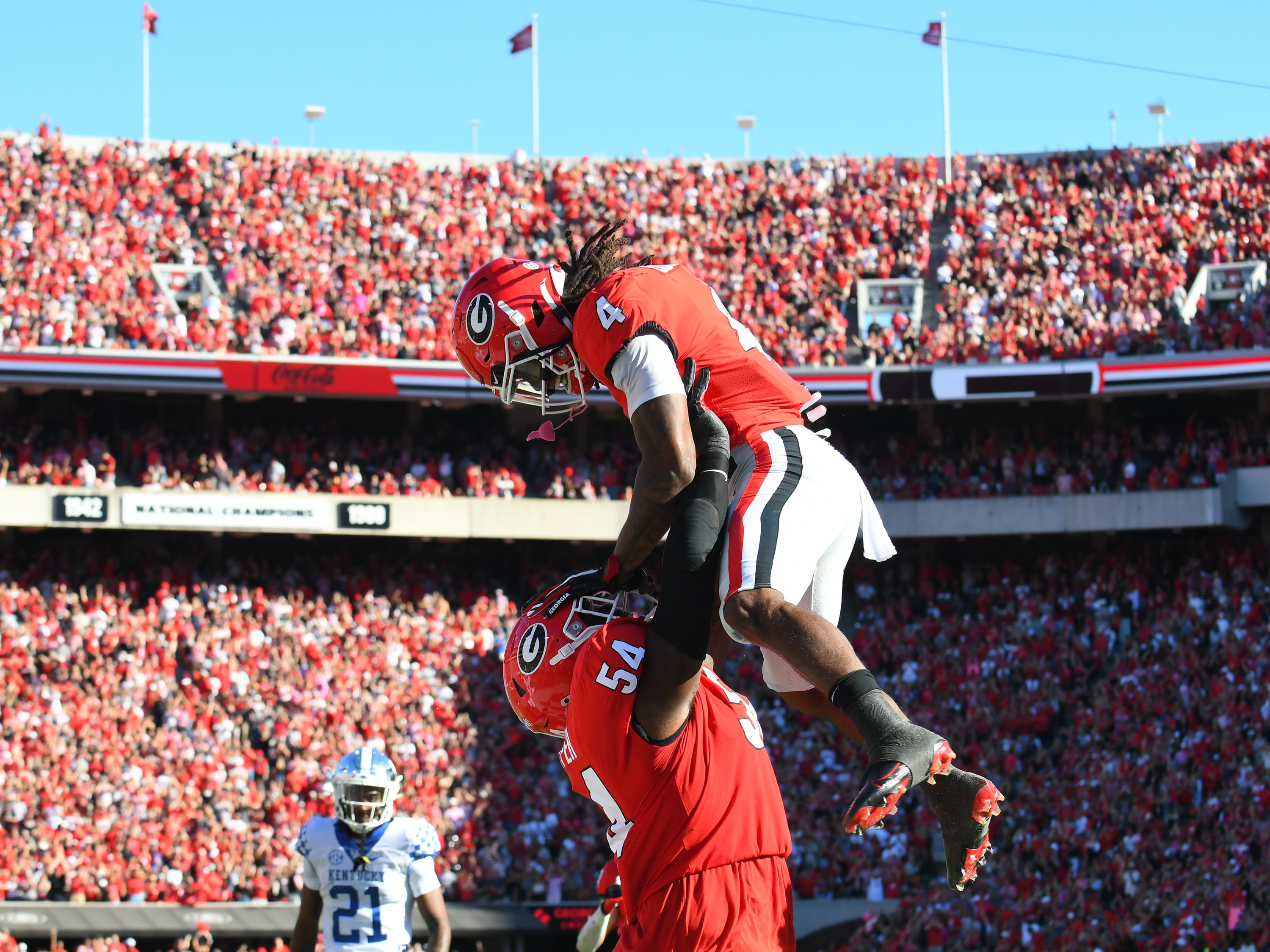 ATHENS, GA - OCTOBER 16: Georgia Bulldogs Offensive Linemen Justin Shaffer (54) and Georgia Bulldogs Running Back James Cook (4) celebrate during the college football game between the Kentucky Wildcats and the Georgia Bulldogs on October 16, 2021, at Sanford Stadium in Athens, GA. (Photo by Jeffrey Vest/Icon Sportswire via Getty Images)
