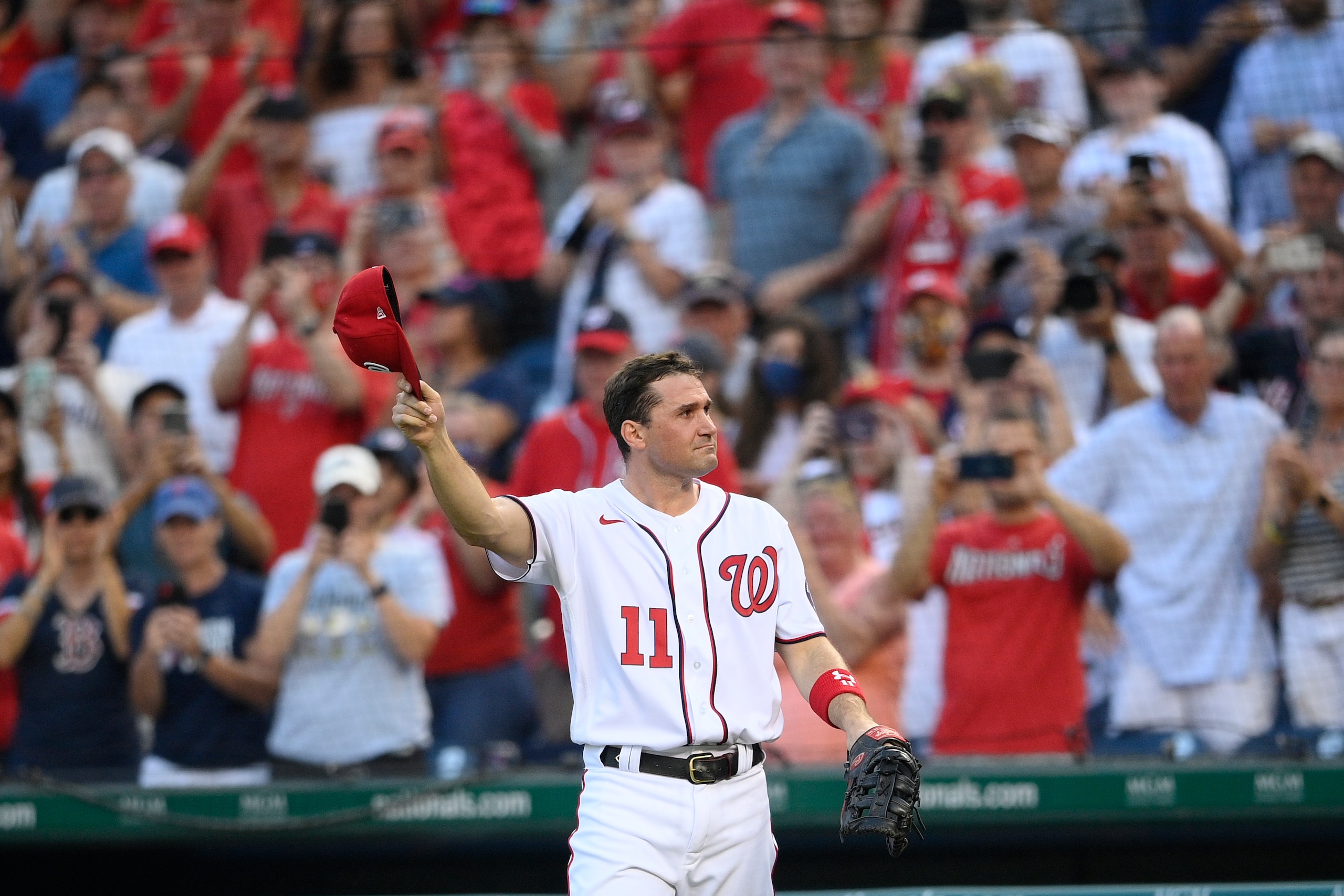 Washington Nationals' Ryan Zimmerman doffs his cap to the crowd after he came out of the game before the eighth inning of a baseball game against the Boston Red Sox, Sunday, Oct. 3, 2021, in Washington. The Red Sox won 7-5. (AP Photo/Nick Wass)