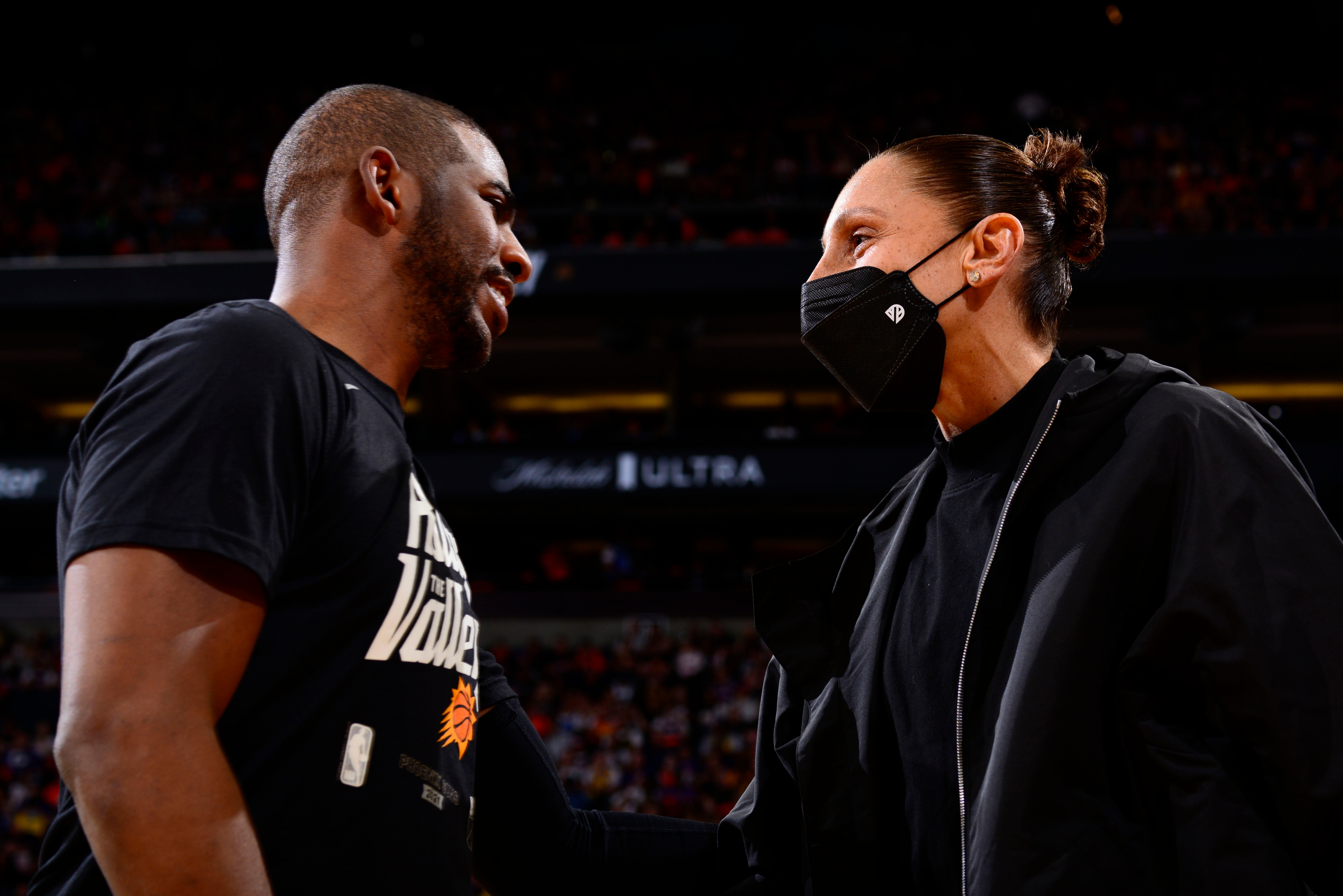 PHOENIX, AZ - JUNE 1: Chris Paul #3 of the Phoenix Suns talks with Diana Taurasi #3 of the Phoenix Mercury during Round 1, Game 5 of the 2021 NBA Playoffs on June 1, 2021 at Phoenix Suns Arena in Phoenix, Arizona. NOTE TO USER: User expressly acknowledges and agrees that, by downloading and or using this photograph, user is consenting to the terms and conditions of the Getty Images License Agreement. Mandatory Copyright Notice: Copyright 2021 NBAE (Photo by Barry Gossage/NBAE via Getty Images)