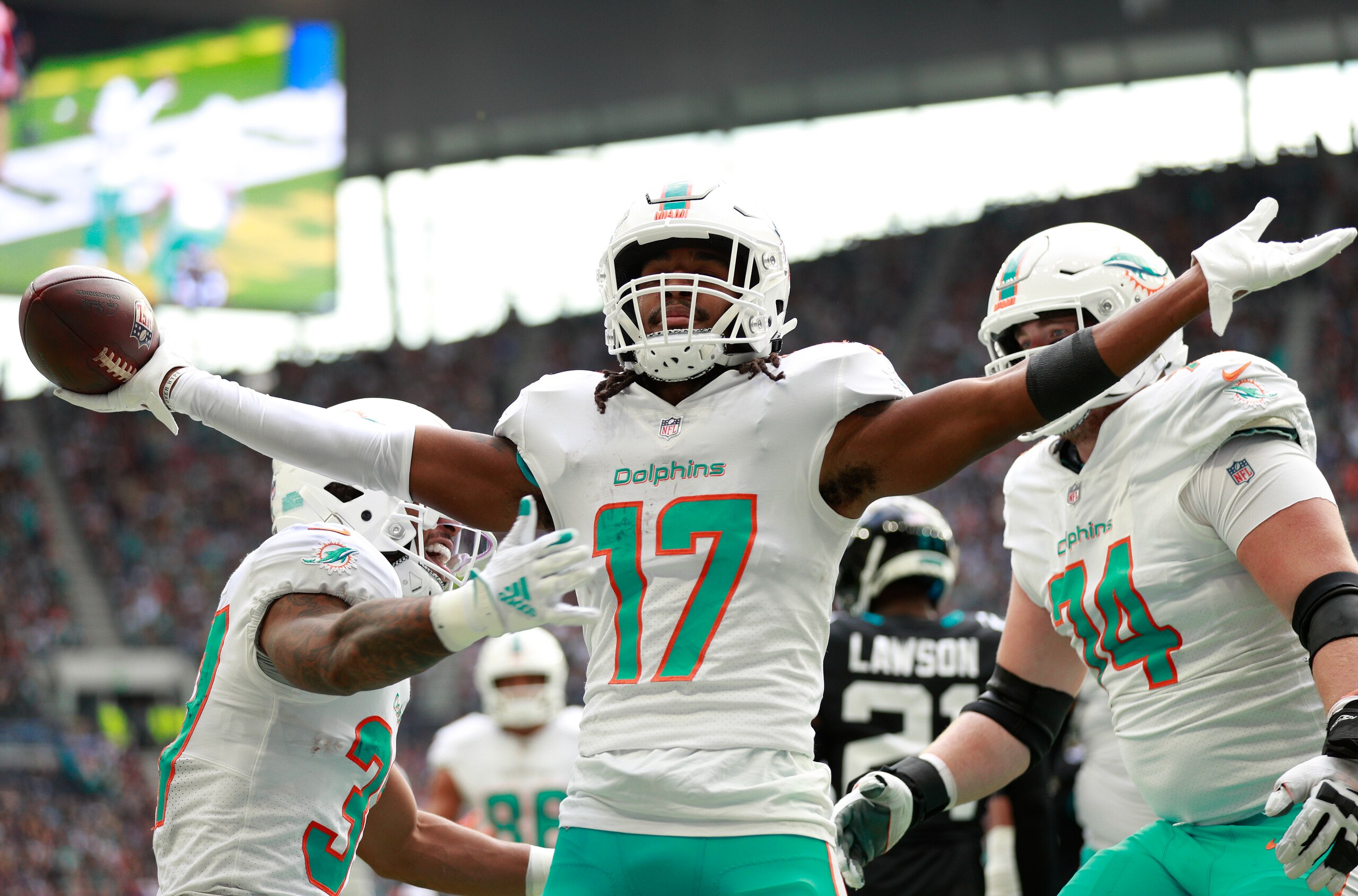 Miami Dolphins wide receiver Jaylen Waddle (17) celebrates after scoring a touchdown during the first half of an NFL football game between the Miami Dolphins and the Jacksonville Jaguars at the Tottenham Hotspur stadium in London, England, Sunday, Oct. 17, 2021. (AP Photo/Ian Walton)