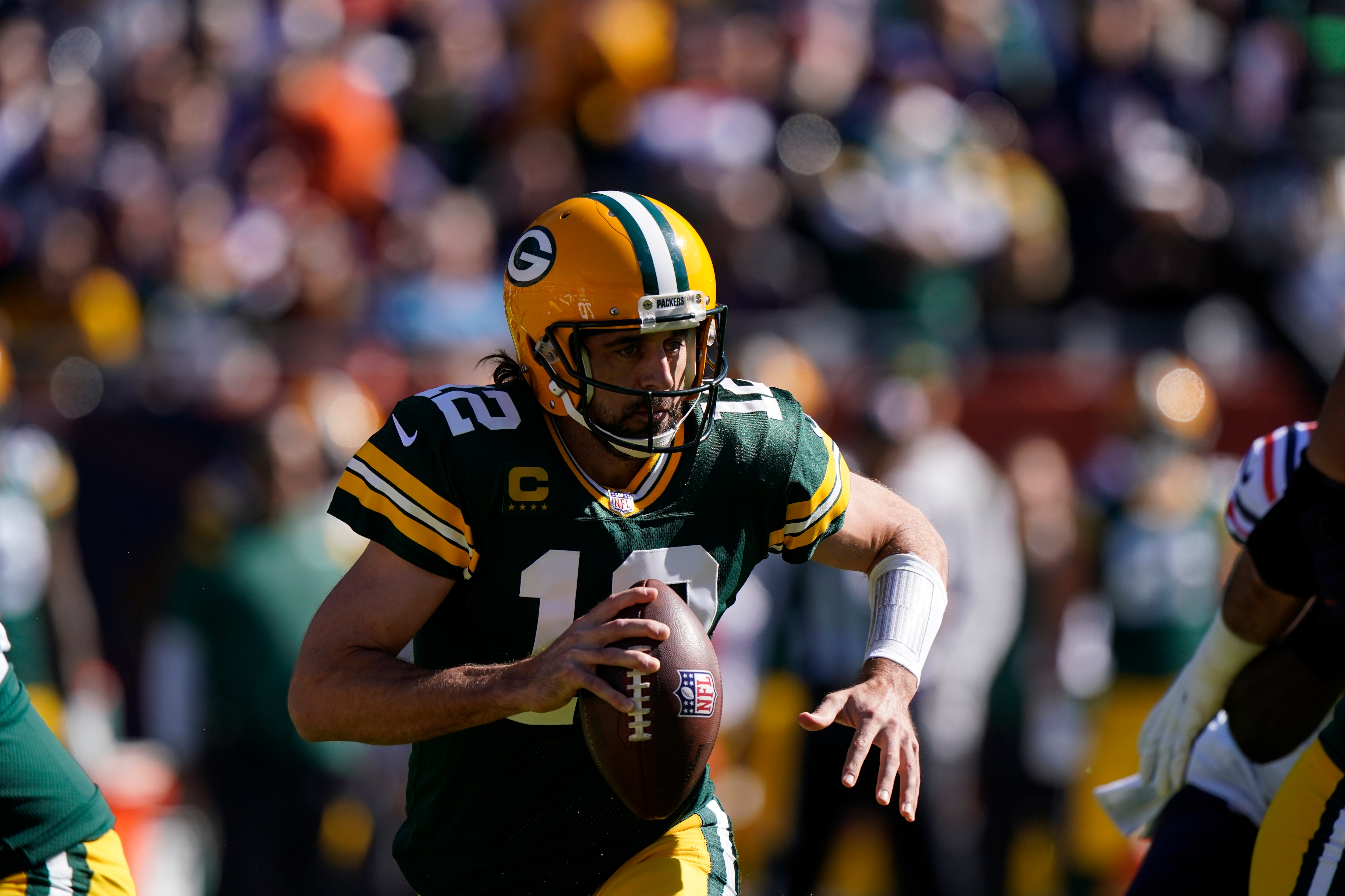Green Bay Packers' Aaron Rodgers scrambles during the first half of an NFL football game Chicago Bears Sunday, Oct. 17, 2021, in Chicago. (AP Photo/Nam Y. Huh)