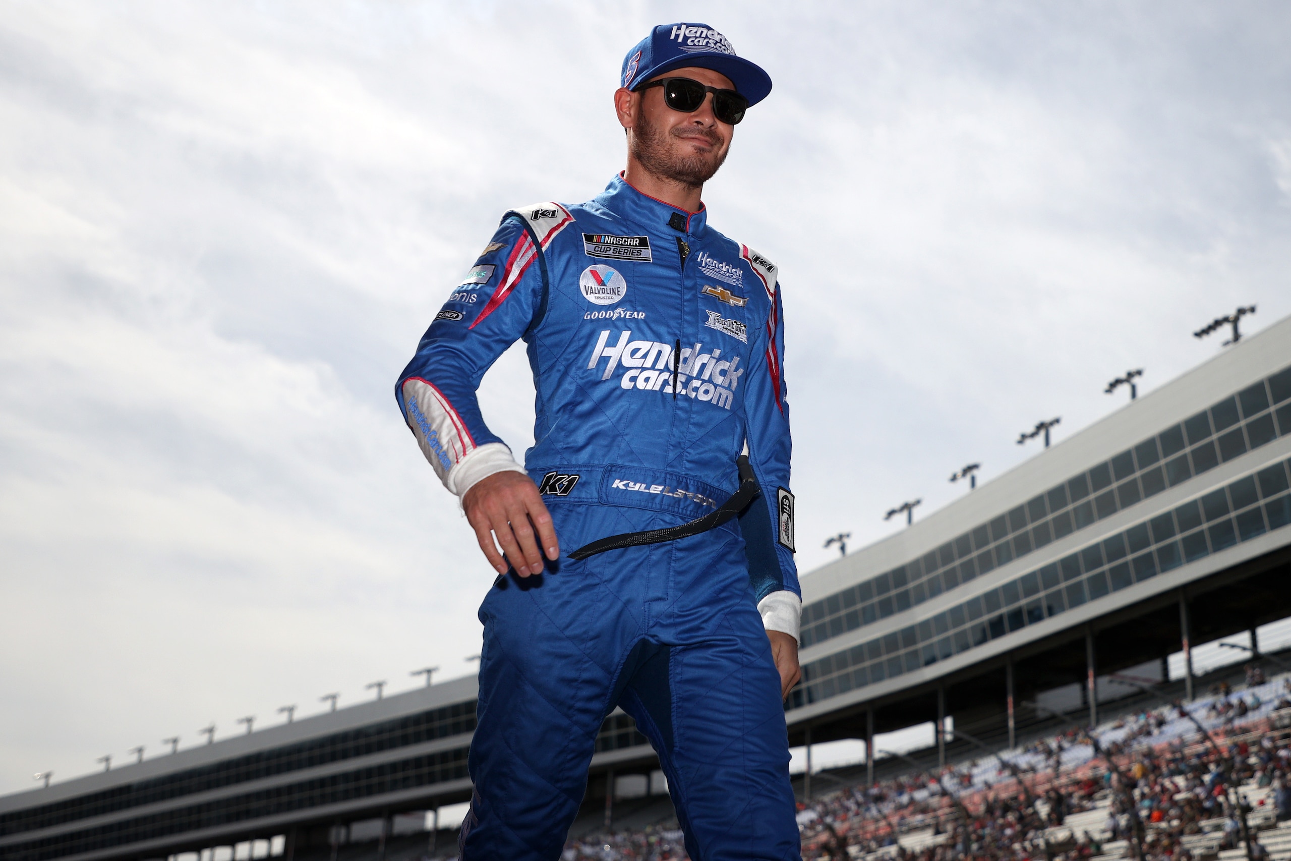 FORT WORTH, TEXAS - OCTOBER 17: Kyle Larson, driver of the #5 HendrickCars.com Chevrolet, walks on stage during pre-race ceremonies prior to the NASCAR Cup Series Autotrader EchoPark Automotive 500 at Texas Motor Speedway on October 17, 2021 in Fort Worth, Texas. (Photo by Chris Graythen/Getty Images)