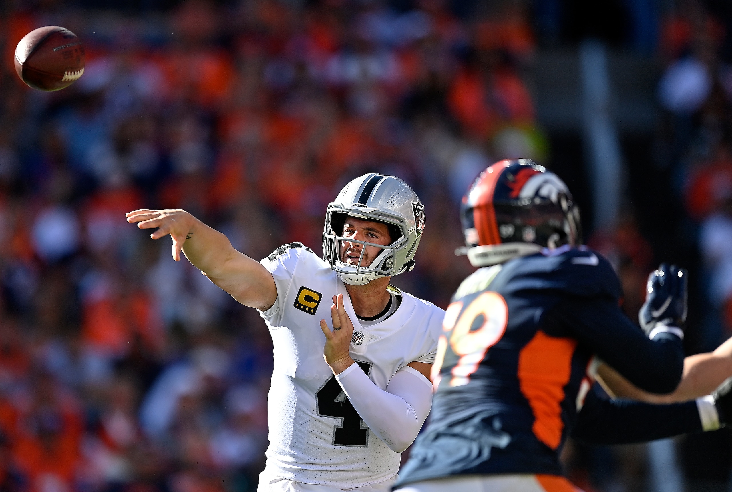 DENVER, COLORADO - OCTOBER 17: Derek Carr #4 of the Las Vegas Raiders throws during the second quarter against the Denver Broncos at Empower Field At Mile High on October 17, 2021 in Denver, Colorado. (Photo by Dustin Bradford/Getty Images)