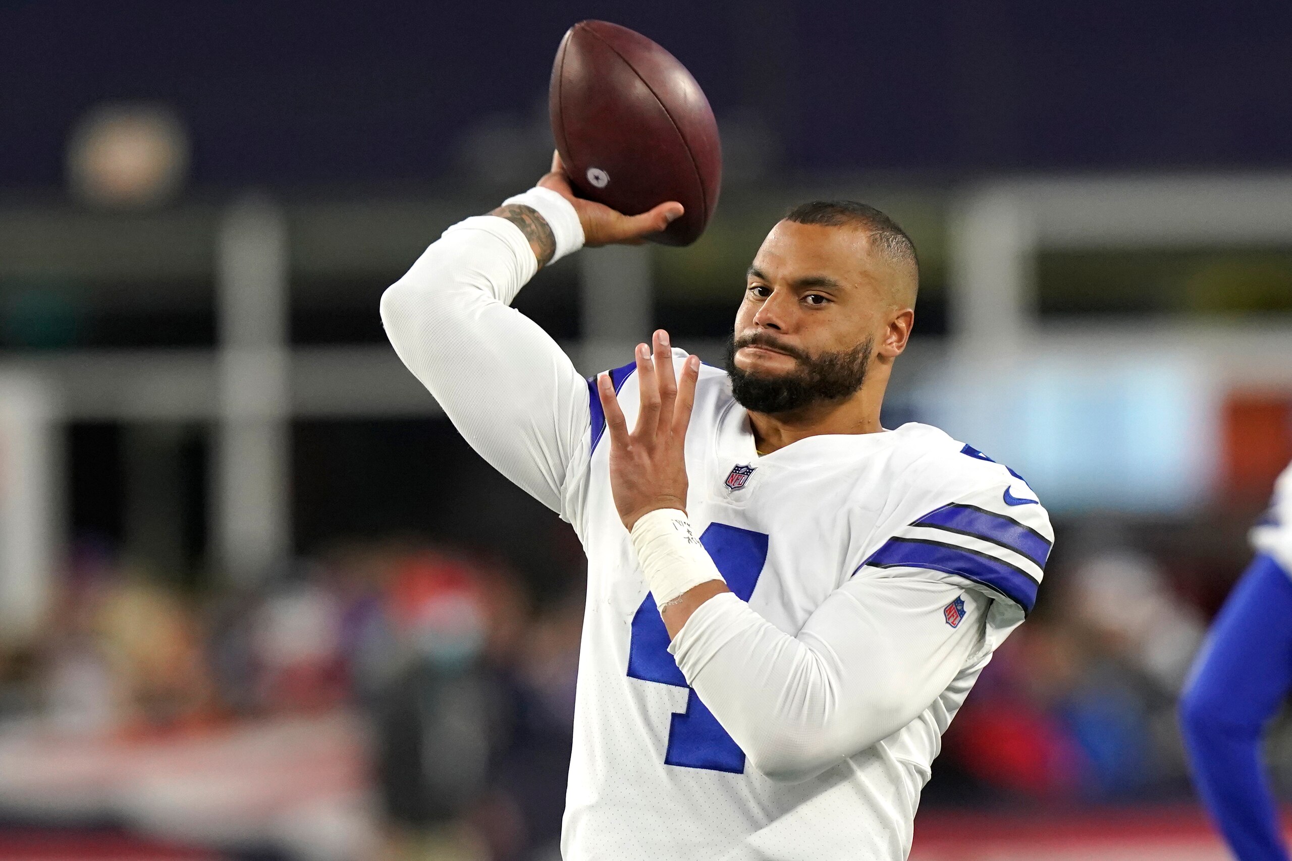 Dallas Cowboys quarterback Dak Prescott (4) warms up prior to the second half of an NFL football game, Sunday, Oct. 17, 2021, in Foxborough, Mass. (AP Photo/Steven Senne)