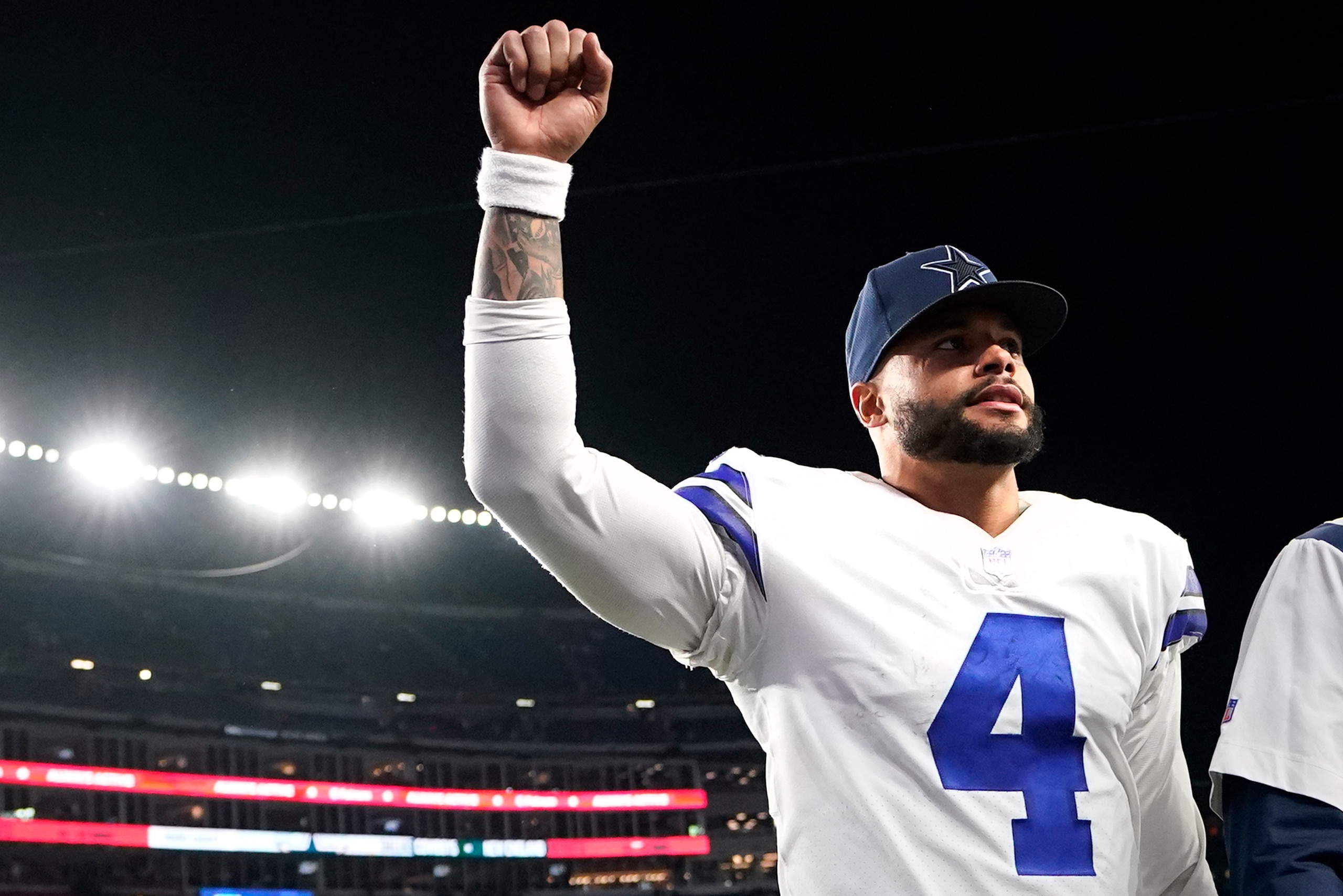 Dallas Cowboys quarterback Dak Prescott (4) pumps his fist towards fans after an overtime win against the New England Patriots following an NFL football game, Sunday, Oct. 17, 2021, in Foxborough, Mass. (AP Photo/Steven Senne) Dallas Cowboys quarterback Dak Prescott (4) pumps his fist towards fans after an overtime win against the New England Patriots following an NFL football game, Sunday, Oct. 17, 2021, in Foxborough, Mass. (AP Photo/Steven Senne)