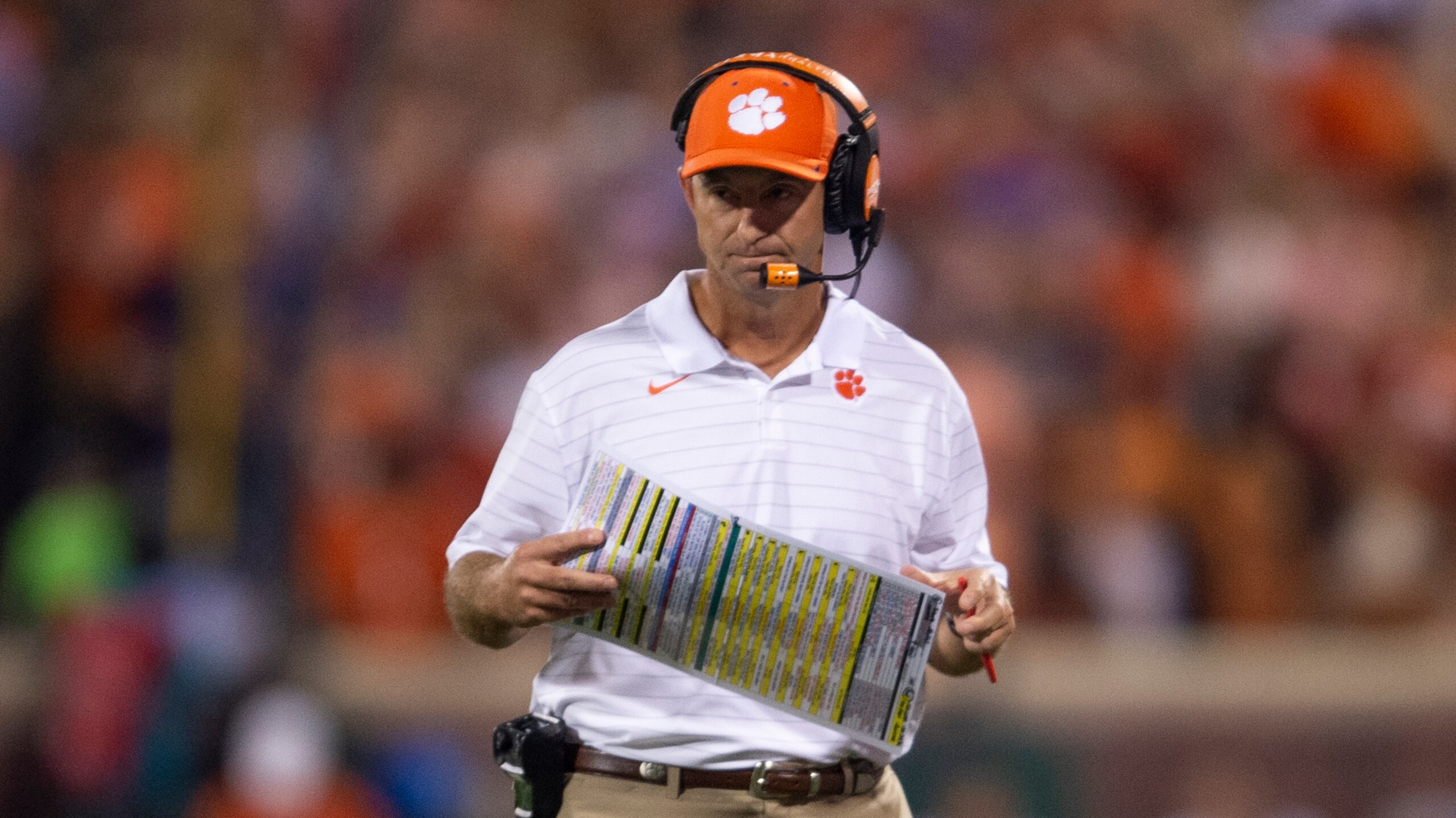 Clemson head coach Dabo Swinney looks at his play card during the first half of an NCAA college football game against Boston College Saturday, Oct. 2, 2021, in Clemson, S.C. (AP Photo/Hakim Wright Sr.)